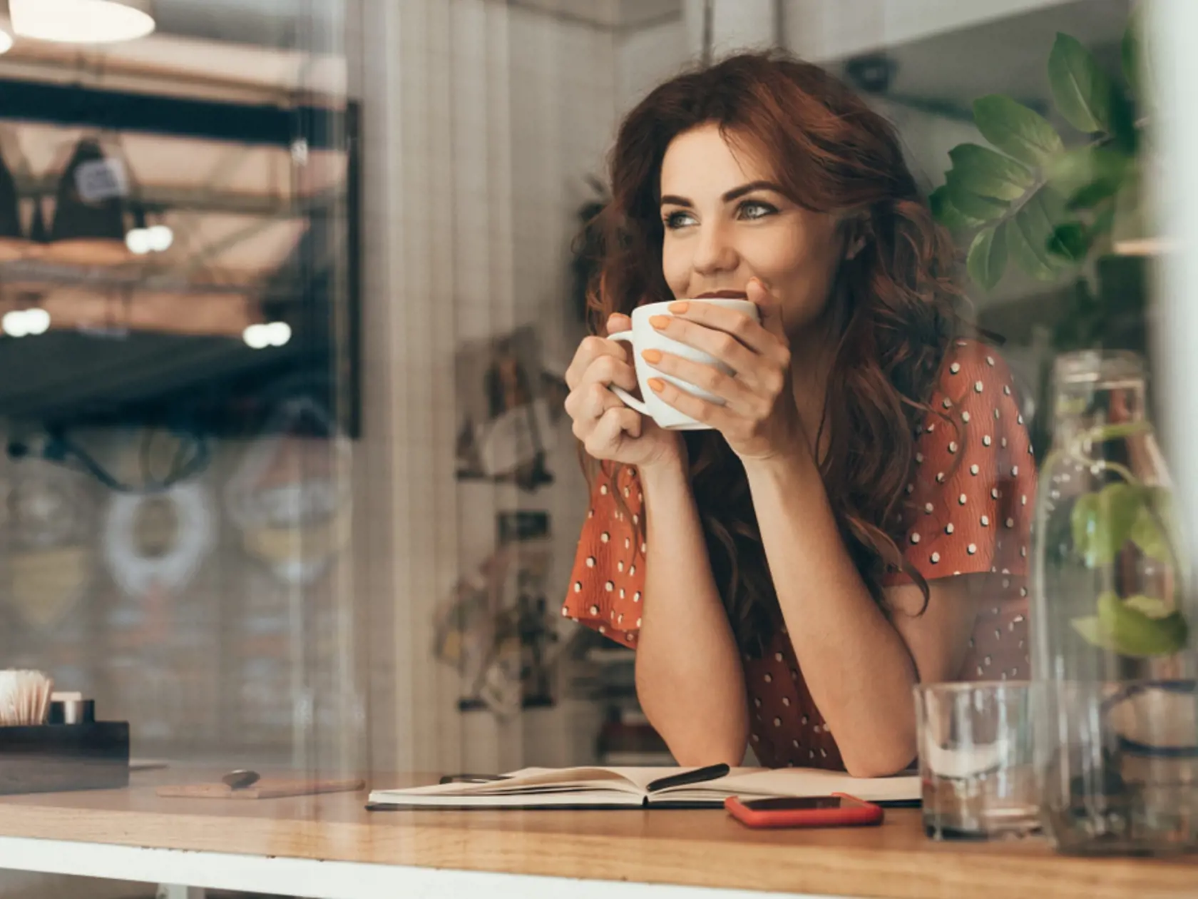 Portrait,Of,Young,Woman,Drinking,Coffee,At,Table,With,Notebook