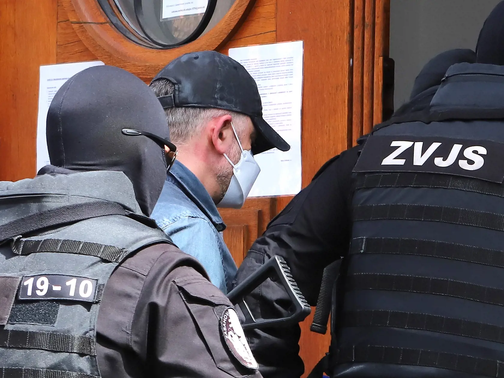 Sudca pre prípravné konanie Špecializovaného trestného súdu (ŠTS), pracovisko Banská Bystrica, rozhoduje o predĺžení väzby pre bývalého šéfa protikorupčnej jednotky Roberta K., v ktorej je od novembra 2020. NAKA ho vtedy zadržala v rámci policajnej akcie Očistec. Na snímke eskorta privádza obvineného bývalého šéfa protikorupčnej jednotky Roberta K. do budovy Špecializovaného trestného súdu (ŠTS) v Banskej Bystrici 10. mája 2021. FOTO TASR - Ján Krošlák