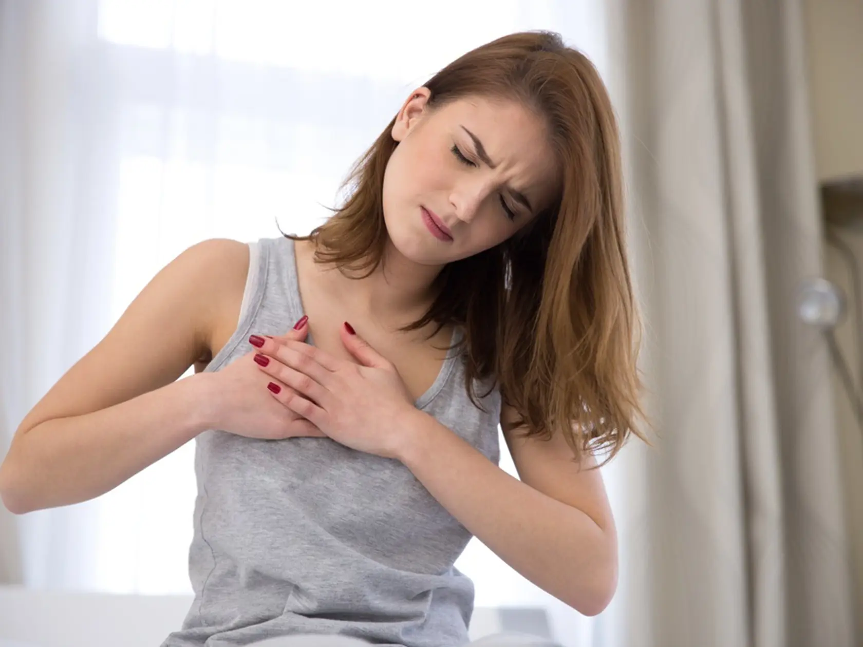 Young,Woman,In,Pajamas,Having,Heart,Attack