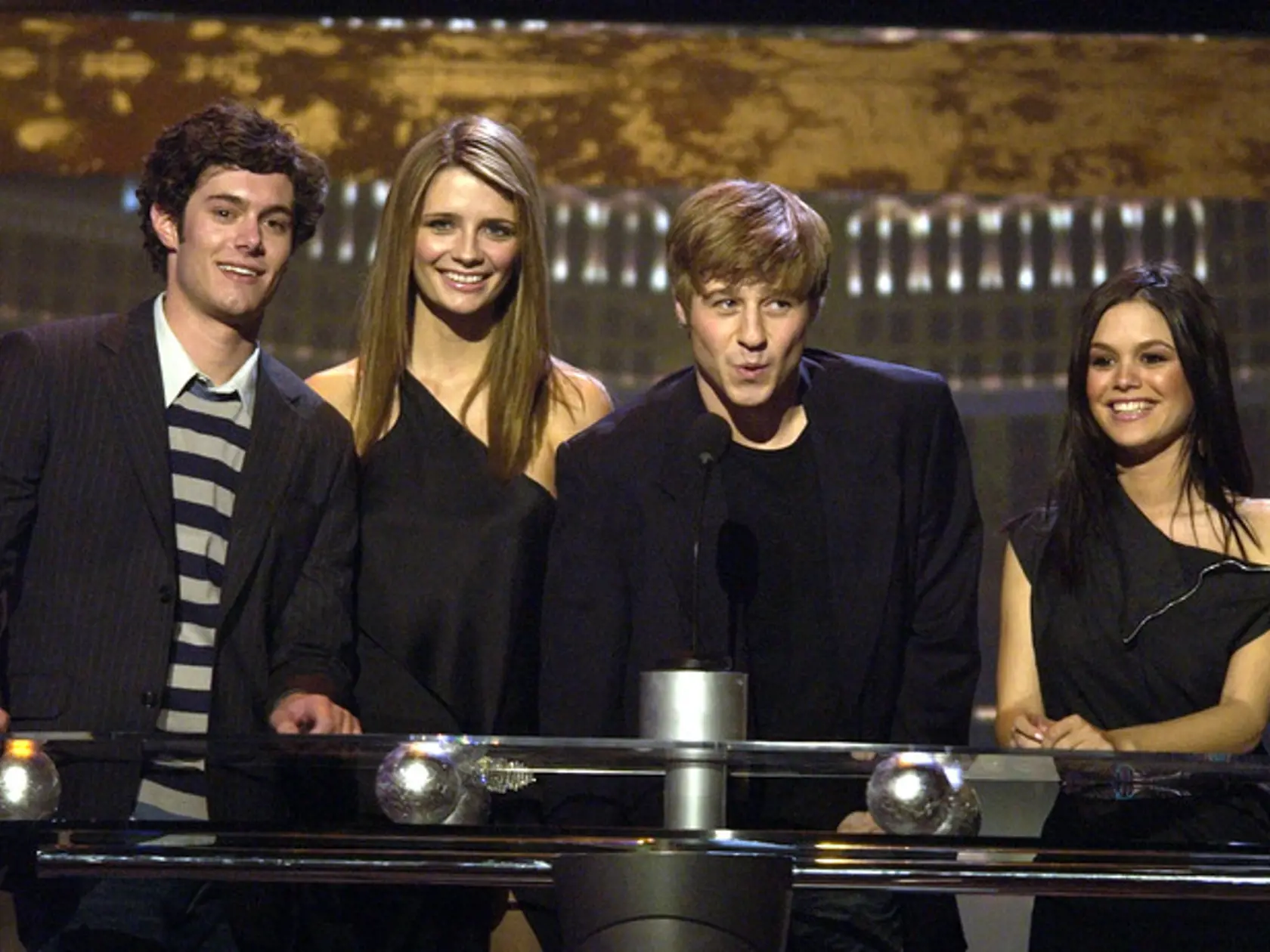 ** FILE ** Cast members of the television show "The O.C.," from left, Adam Brody, Mischa Barton, Benjamin McKenzie and Rachel Bilson appear as presenters in this Dec. 10, 2003 file photo during the Billboard Music Awards in Las Vegas. The once-hot TV series about wealthy Southern California teenagers has been canceled. The final episode of the drama will air 9 p.m. EST Thursday, Feb. 22, 2006, Fox TV and Warner Bros. Television Production Inc. said Wednesday, Jan 3. (AP Photo/Joe Cavaretta, Fi
