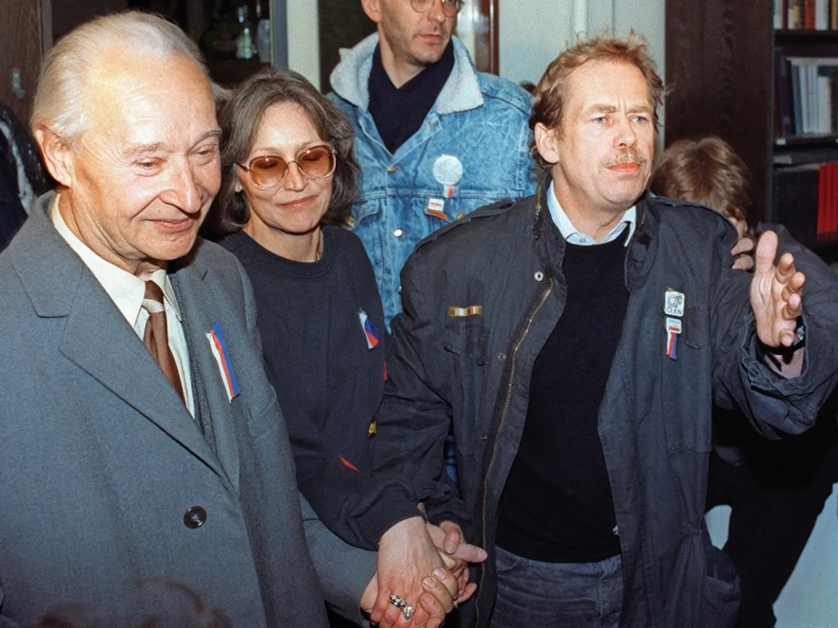 Vaclav Havel (R), a dissident playwright and leading member of the Czechoslovak opposition Civic Forum, who drafted large parts of Charter 77, the declaration which helped attract international attention to the civil rights abuses in Czechoslovakia, former "Prague Spring" leader Slovak Alexander Dubcek (L) and Czech dissident singer Marta Kubisova (C) join hands as they walk to address a rally of 200,000 demonstrators gathered on Prague's Wenceslas Square, calling for the resignation of the comm