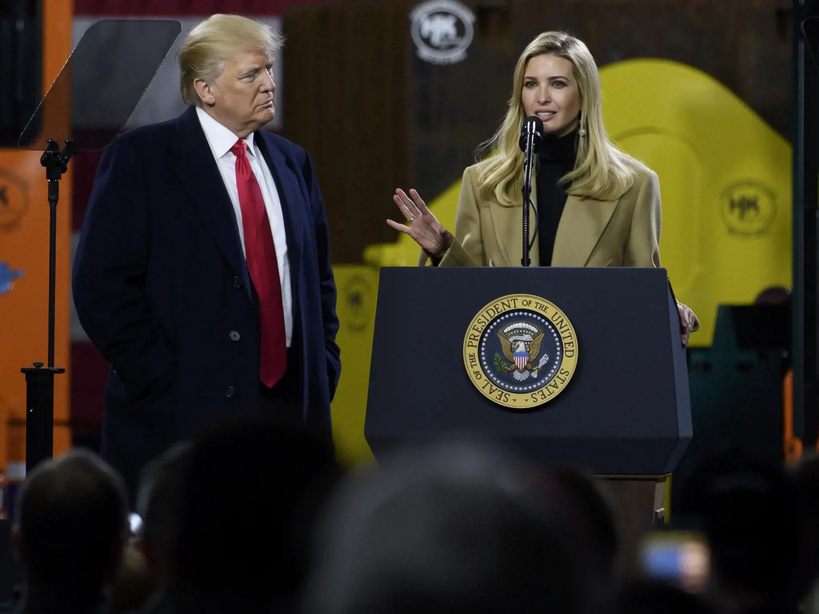 CORAOPOLIS, PA - JANUARY 18: President Donald Trump listens to his daughter, Ivanka Trump, speak to supporters at a rally at H&K Equipment, a rental and sales company for specialized material handling solutions on January 18, 2018 in Coraopolis, Pennsylvania.  Trump visited the facility for a factory tour and to offer remarks to supporters and employees following the administration's new tax plan. (Photo by Jeff Swensen/Getty Images)