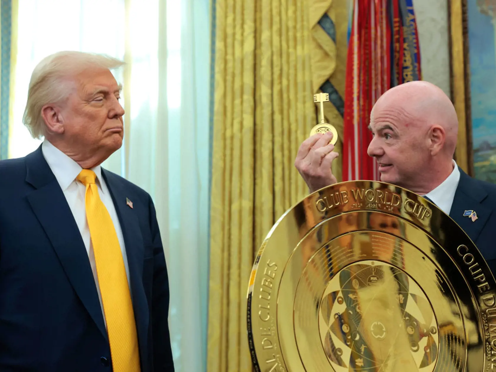 WASHINGTON, DC - MARCH 07: President of Fédération Internationale de Football Association (FIFA) Gianni Infantino (R) unveils the Club World Cup trophy alongside U.S. President Donald Trump in the Oval Office at the White House on March 07, 2025 in Washington, DC. President Trump signed an executive order establishing a White House Task Force for the 2026 World Cup.  (Photo by Anna Moneymaker/Getty Images)