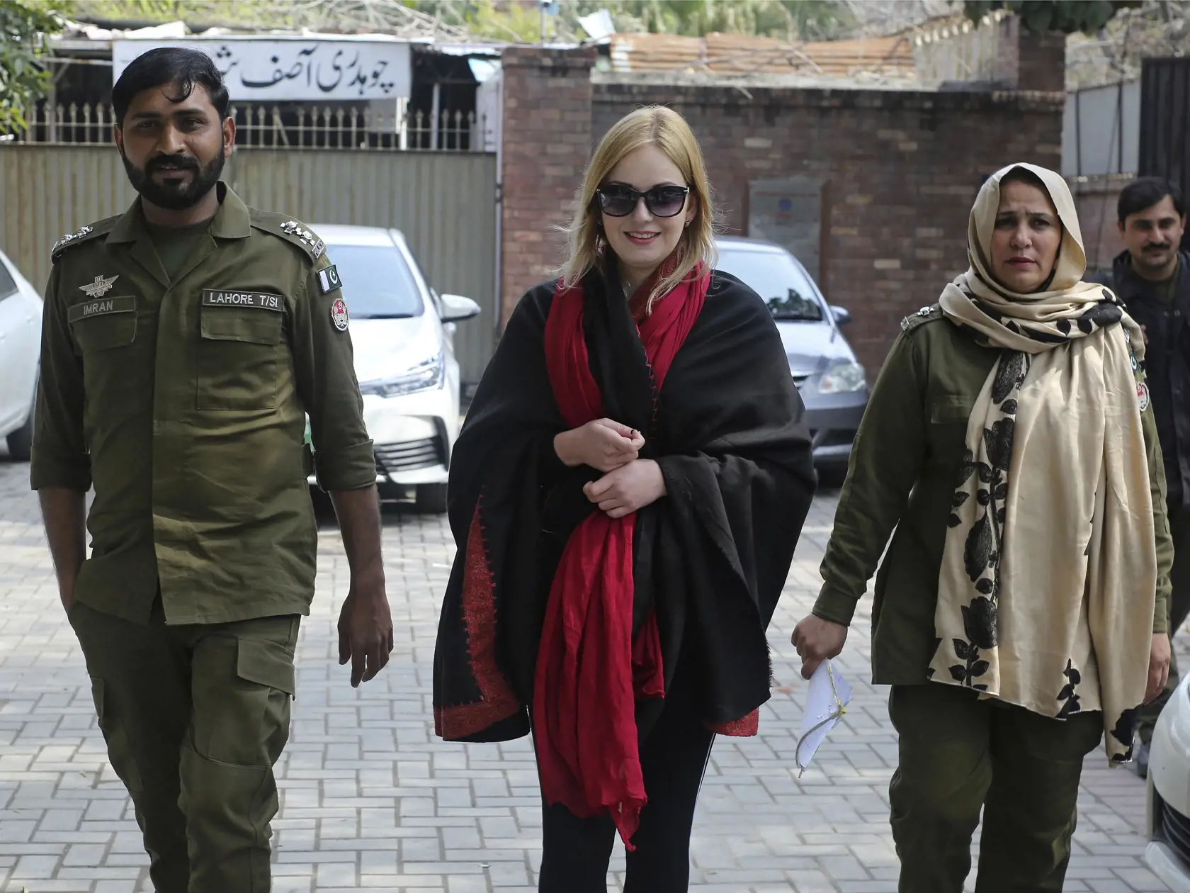 Pakistani police officers escort Tereza Hluskova, center, a Czech citizen, to a court in Lahore, Pakistan, Tuesday, Feb. 19, 2019. Hluskova was arrested last year on charges of attempting to smuggle heroin from Pakistan to Abu Dhabi. Since her arrest in 2018, she told investigators that she came to Pakistan to work as a model but that someone put narcotics into her luggage. (AP Photo/K.M. Chaudary)