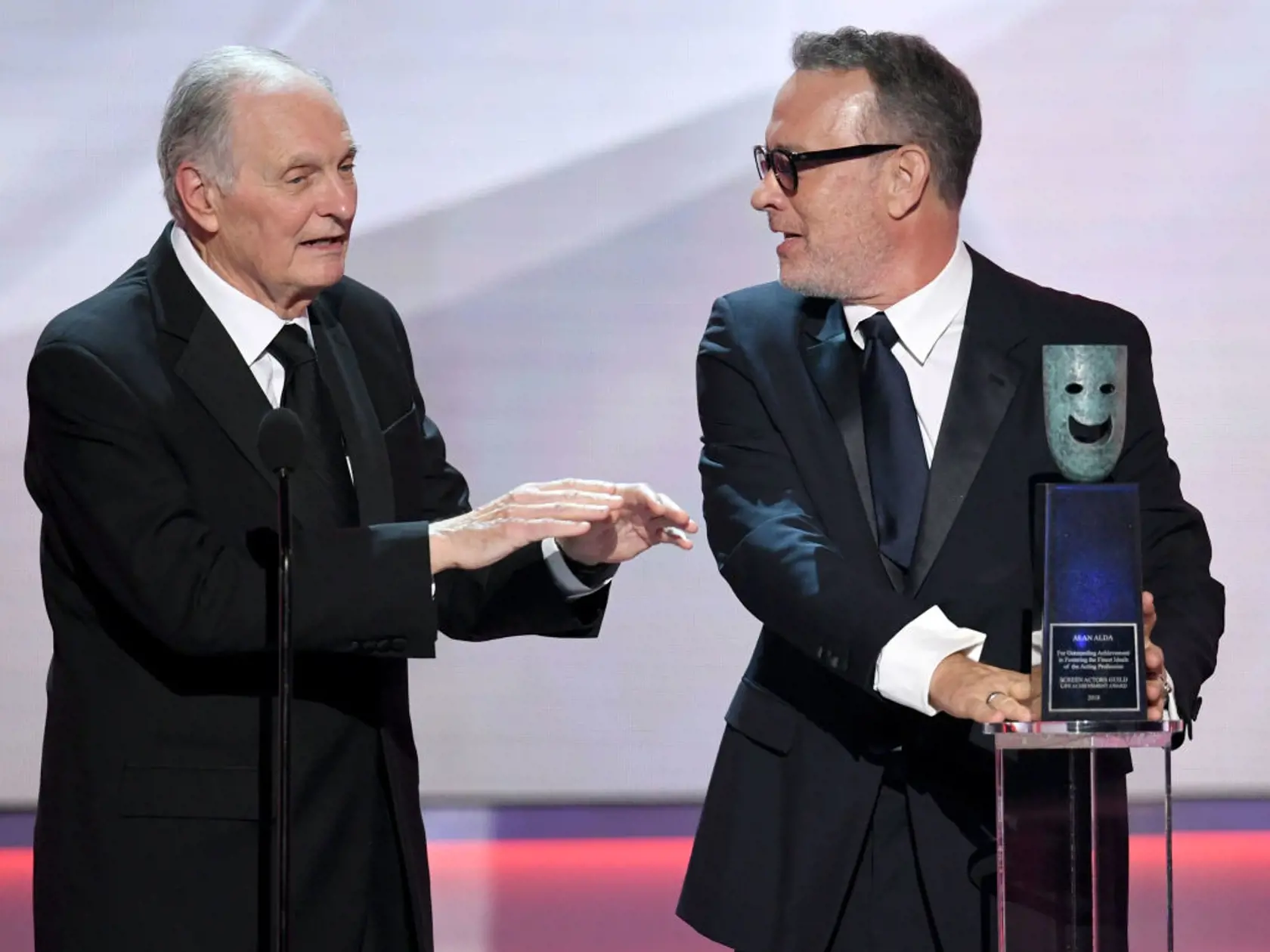 LOS ANGELES, CALIFORNIA - JANUARY 27: Alan Alda receives the SAG Life Achievemant Award from Tom Hanks onstage during the 25th Annual Screen Actors Guild Awards at The Shrine Auditorium on January 27, 2019 in Los Angeles, California. (Photo by Kevin Winter/Getty Images for Turner)