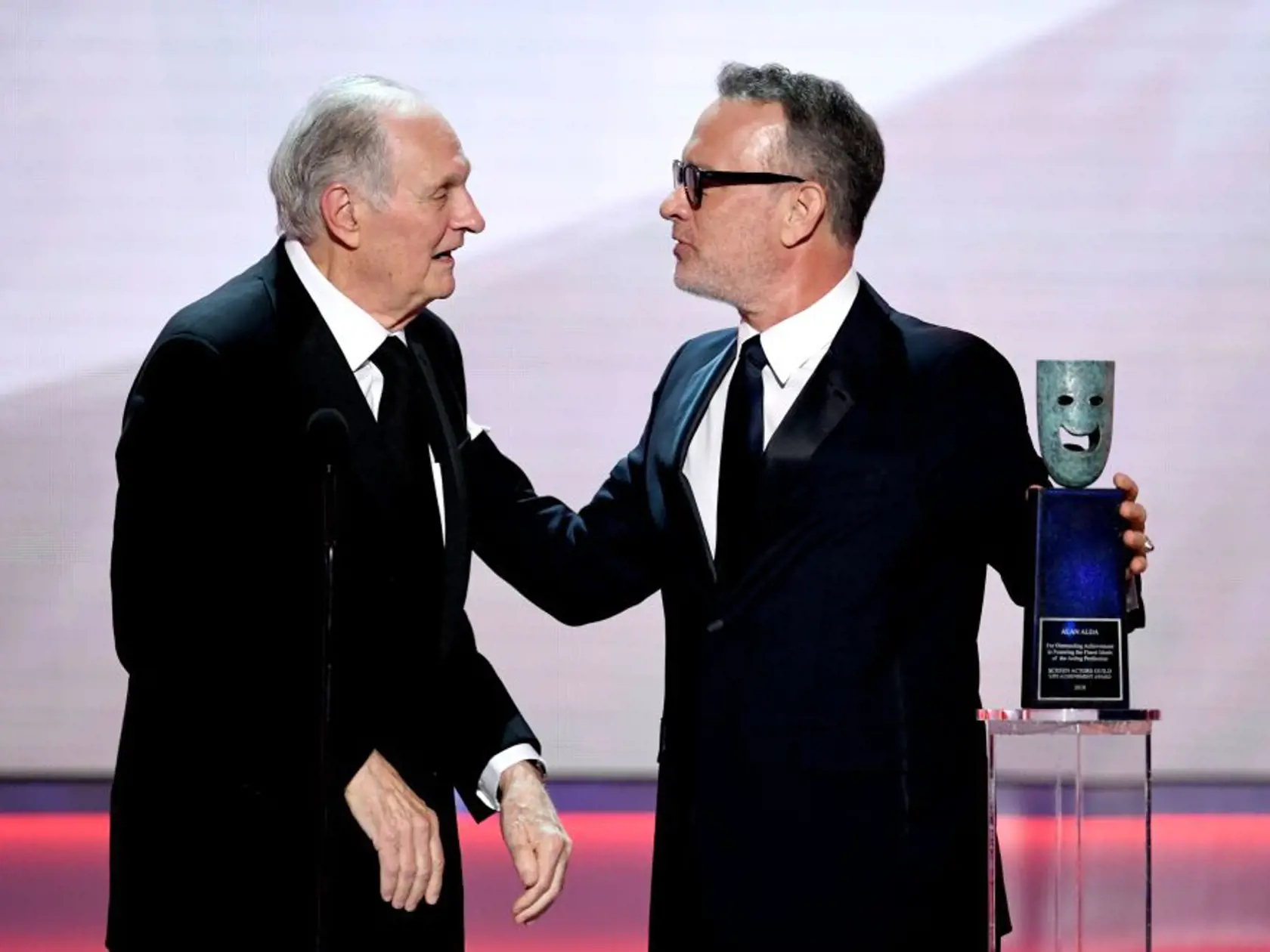 LOS ANGELES, CALIFORNIA - JANUARY 27: Alan Alda receives the SAG Life Achievemant Award from Tom Hanks onstage during the 25th Annual Screen Actors Guild Awards at The Shrine Auditorium on January 27, 2019 in Los Angeles, California. (Photo by Kevin Winter/Getty Images for Turner)