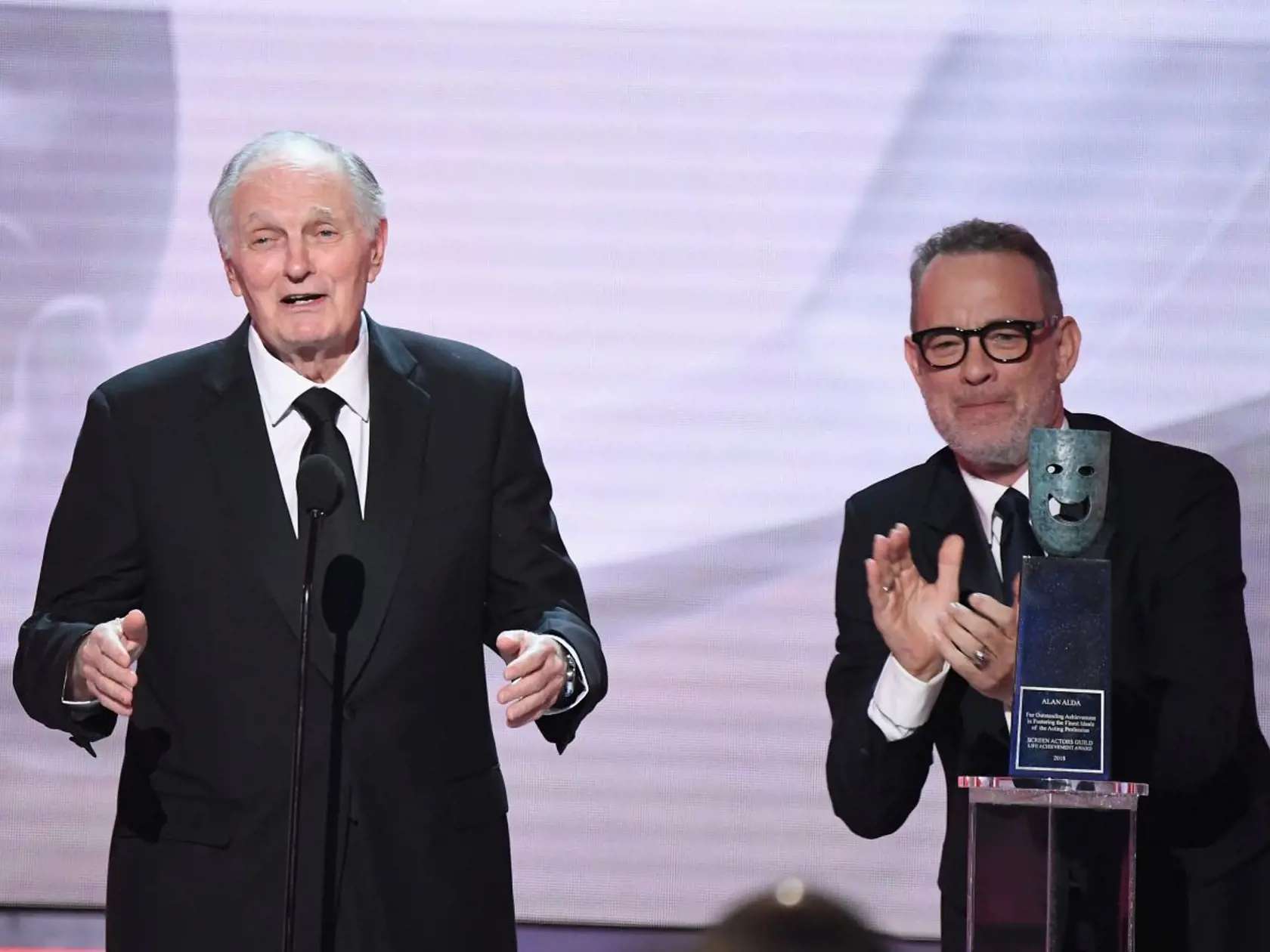 LOS ANGELES, CA - JANUARY 27:  Alan Alda, recipient of the Lifetime Achievement Award, and Tom Hanks speak onstage during the 25th Annual Screen Actors Guild Awards at The Shrine Auditorium on January 27, 2019 in Los Angeles, California.  (Photo by Kevork Djansezian/Getty Images)