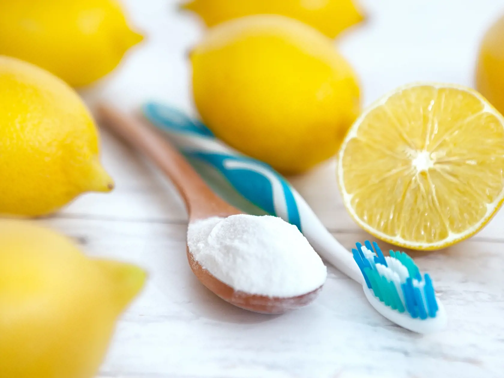 Spoon,With,Baking,Soda,,Lemon,And,Tooth,Brush,On,Wooden