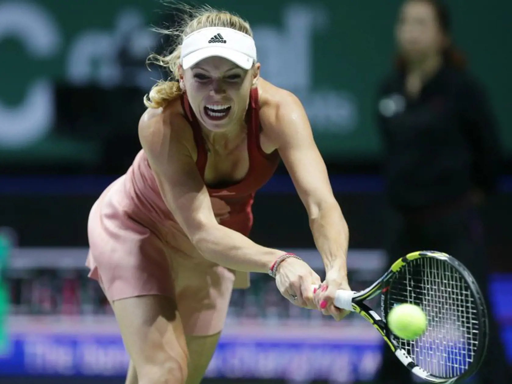 Denmark's Caroline Wozniacki makes a backhand return to Serena Williams of the US during their semifinal match at the WTA tennis finals in Singapore, Saturday, Oct. 25, 2014. (AP Photo/Mark Baker)