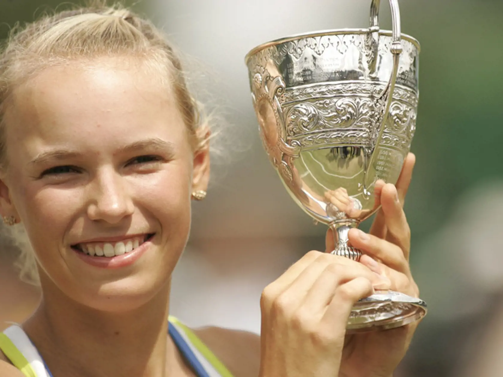 Denmark's Caroline Wozniacki holds the Girl's Championship trophy after her 3-6, 6-1, 6-3 win over Magdalena Rybarikova of Slovakia after their Girl's Singles final at Wimbledon, Saturday, July 8, 2006.  (AP Photo/Alastair Grant)