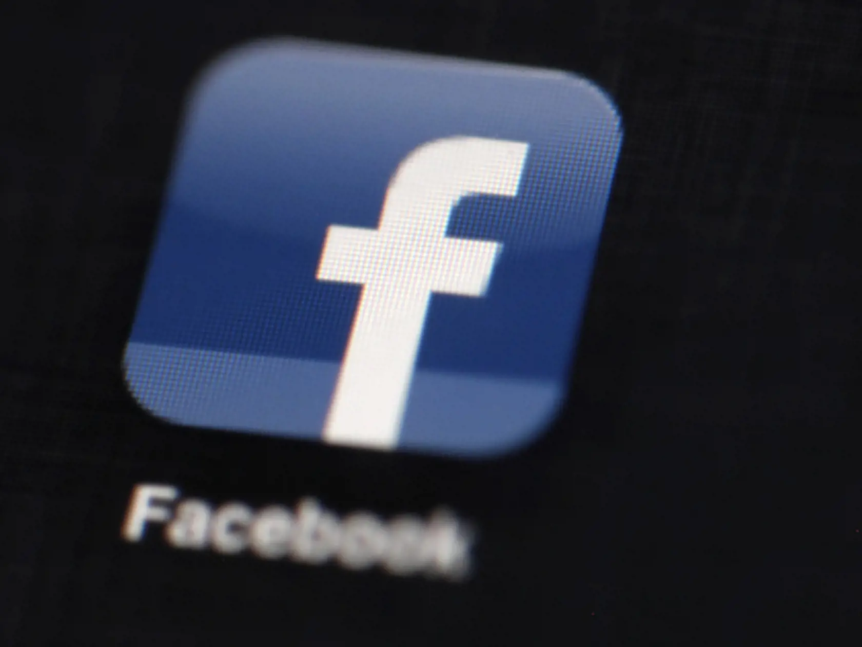 FILE - This May 16, 2012 file photo shows the Facebook logo displayed on an iPad in Philadelphia. More Americans check Facebook daily than read the Bible every day. Much more, by more than a three-to-one margin. As Facebook celebrates its 10th anniversary, the numbers it generates are epic. Facebook says worldwide it has 757 million daily active users. Of those 19 percent are in the U.S. and Canada, so that’s more than 143 million people checking Facebook daily in America. (AP Photo/Matt Rourke,