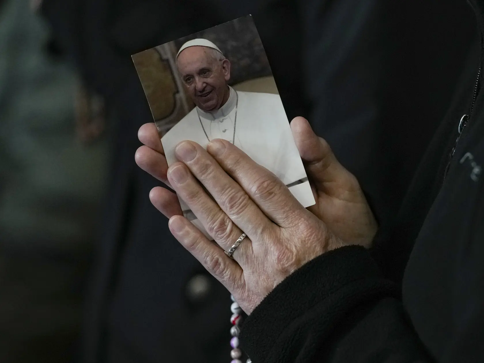 Mníška sa zúčastňuje večerného modlenia ruženca za zdravie pápeža Františka na Námestí sv. Petra vo Vatikáne.