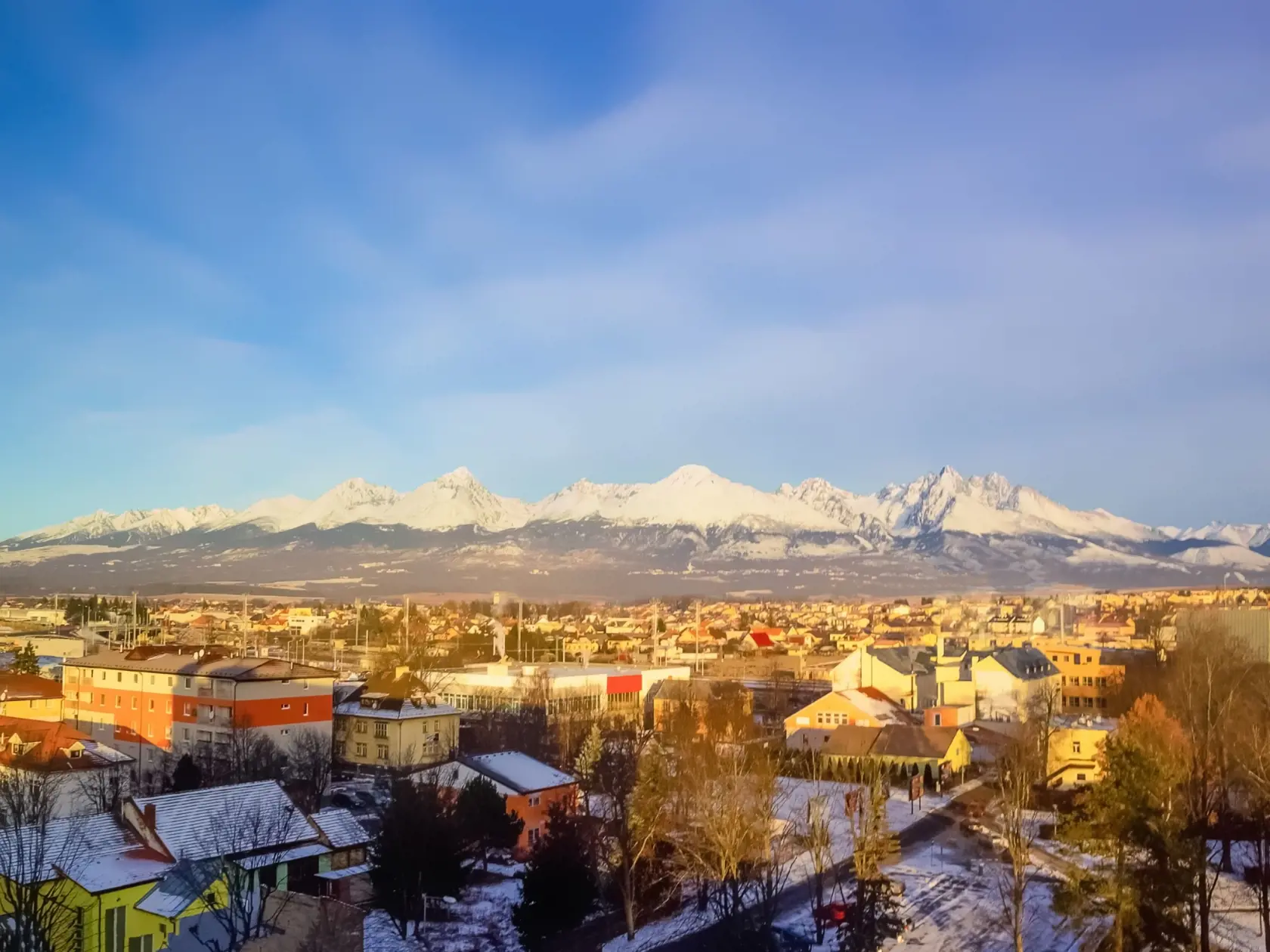 Mountains over colorful buildings and houses at Poprad, Slovakia. Morning