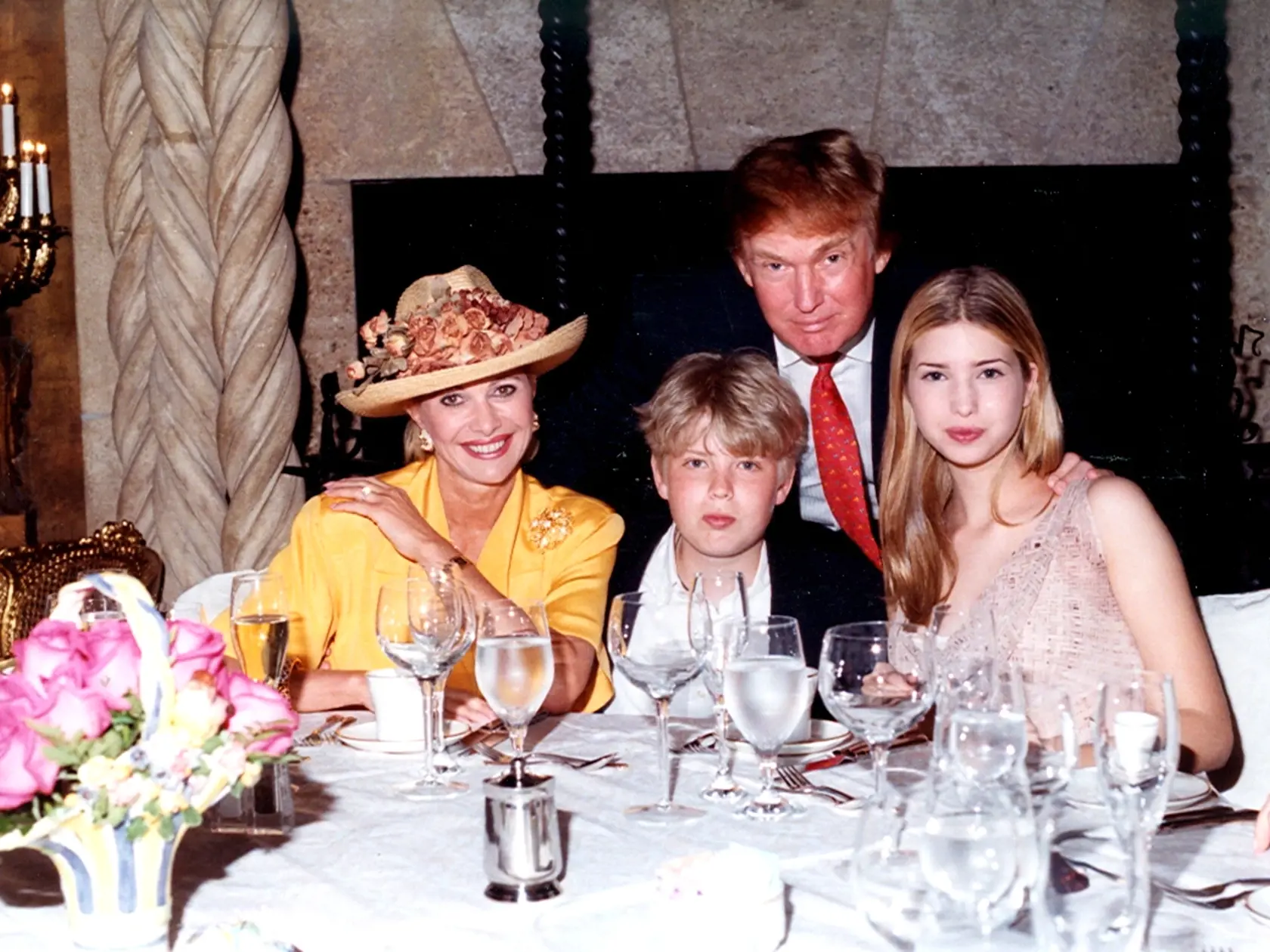 Family portrait of, from left, socialite Ivana Trump, her son Eric Trump, her former husband businessman Donald Trump, and her daughter Ivanka Trump as they sit at a table at the Mar-a-Lago estate, Palm Beach, Florida, 1998. (Photo by Davidoff Studios/Getty Images)