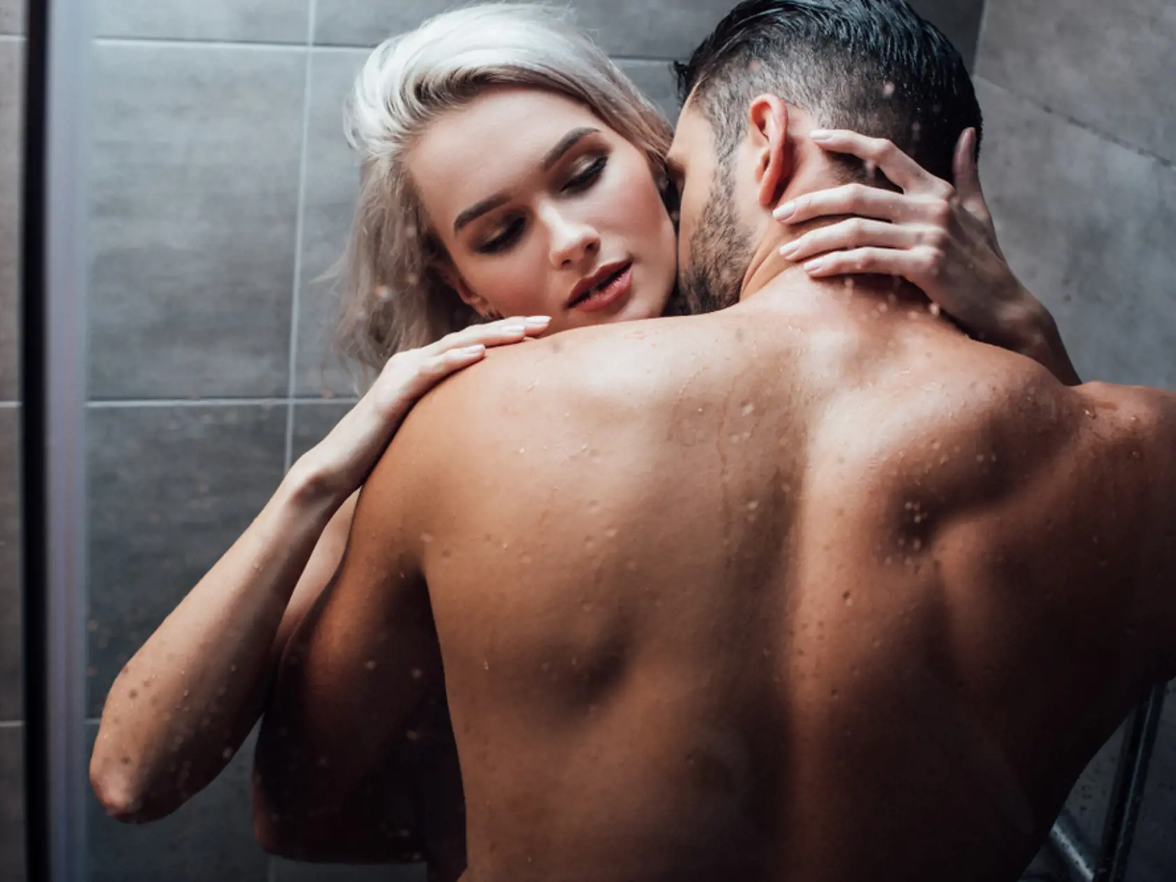 Affectionate,Heterosexual,Couple,Hugging,And,Kissing,While,Taking,Shower,Together