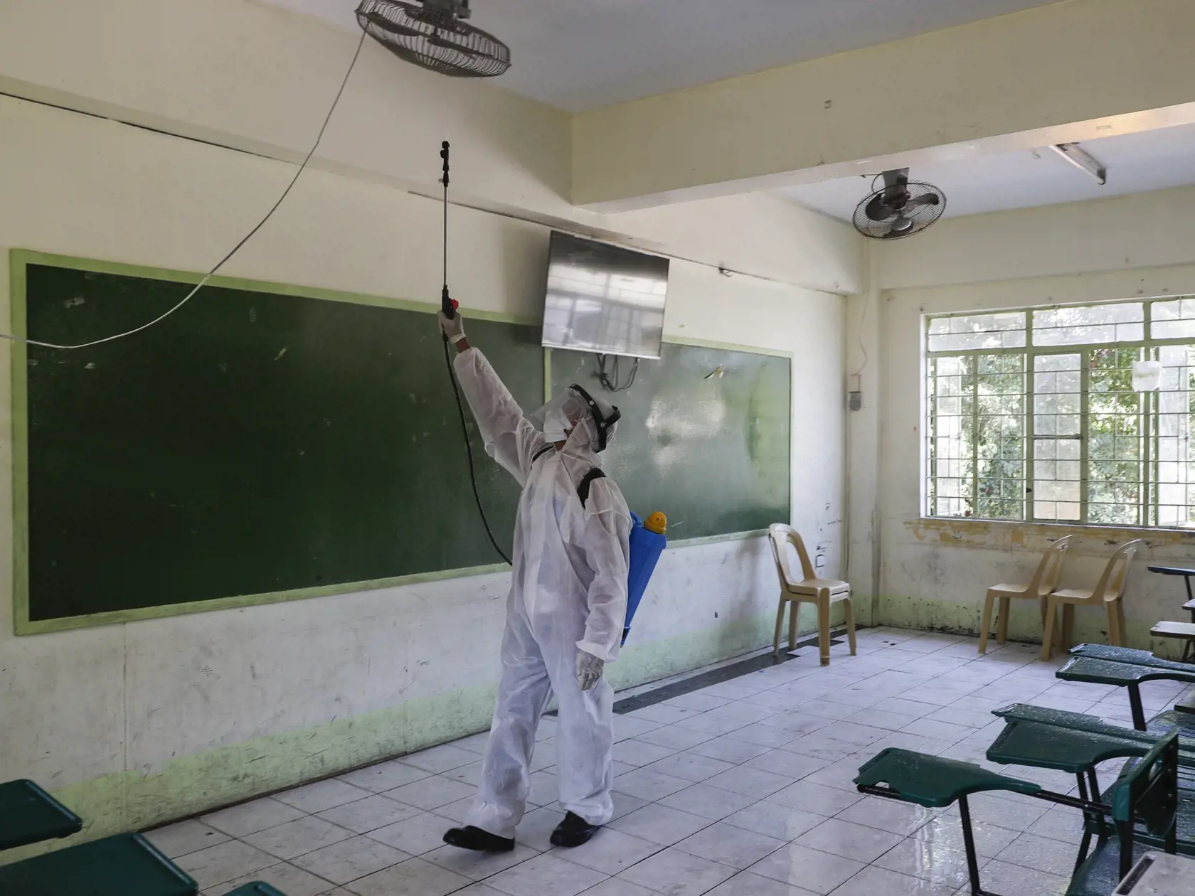 KK17 San Juan - Pracovník v ochrannom oblečení dezinfikuje triedy v škole, ktorú dočasne uzatvorili ako opatrenie pre nový koronavírus vo filipínskom San Juane 9. marca 2020. Filipínsky prezident Rodrigo Duterte vyhlásil stav ohrozenia verejného zdravia. Stalo sa tak po tom, ako v krajine zaznamenali desať prípadov nákazy koronavírusom SARS-CoV2. FOTO TASR/AP
A worker in protective suit sprays disinfectants at a school which has suspended classes as a precautionary measure against the new corona