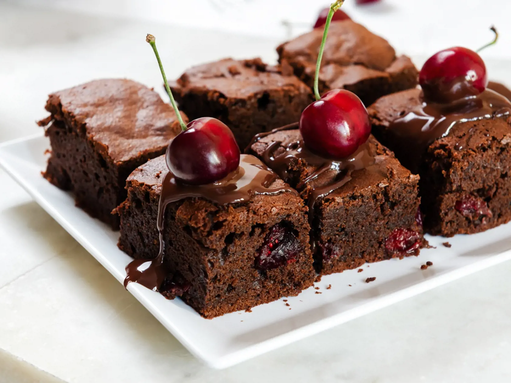 Pieces,Of,Fresh,Brownie,With,Cherries,And,Chocolate,Topping,On
