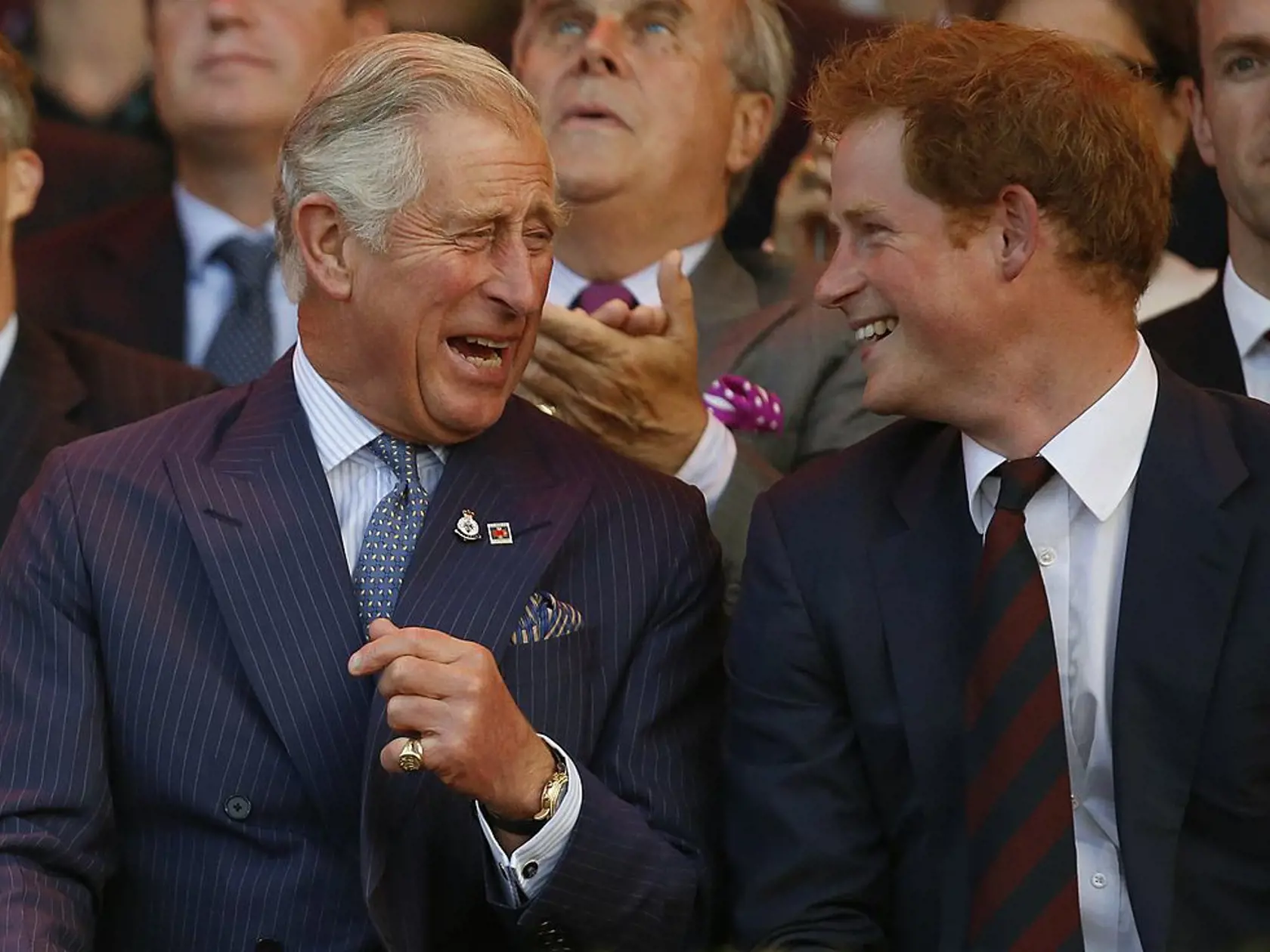 LONDON, UNITED KINGDOM - SEPTEMBER 10:  Prince Charles, Prince of Wales and Prince Harry (R) laugh during the opening ceremony of the Invictus Games at the Queen Elizabeth Park on September 10, 2014 in east London, England. The Invictus Games which will run from September 10-14, is an international sporting event for wounded servicemen and women from 13 countries. (Photo by Luke MacGregor/WPA Pool/Getty Images)