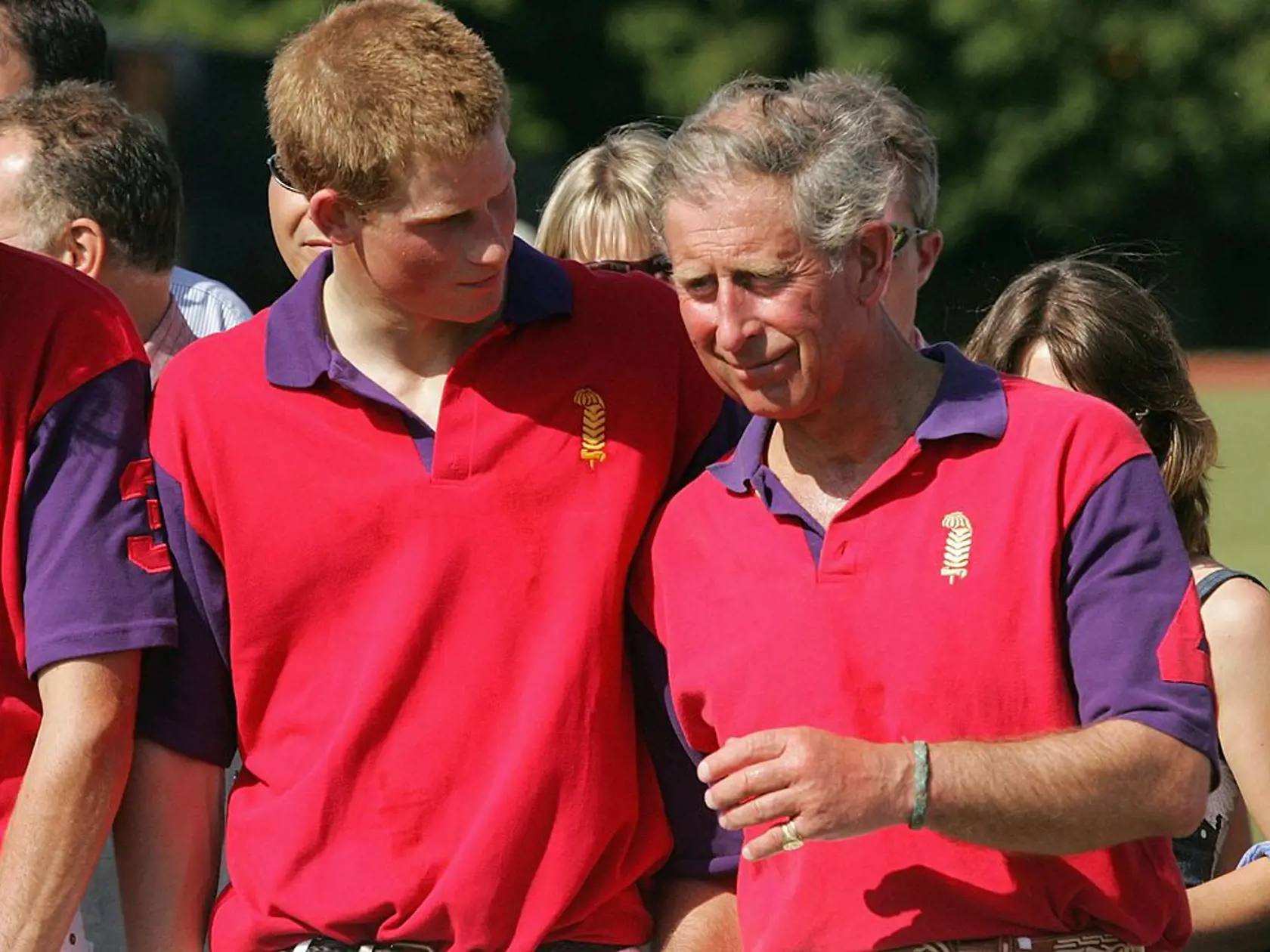GLOUCESTERSHIRE, ENGLAND - JULY 16: Prince Harry and Prince Charles share a joke at the presentation following the Highgrove Polo Team match against Laird polo team in the St James Place charity polo match at Beaufort Polo Club on July 16, 2005 in Tetbury, England. (Photo by Matt Cardy/Getty Images) 
