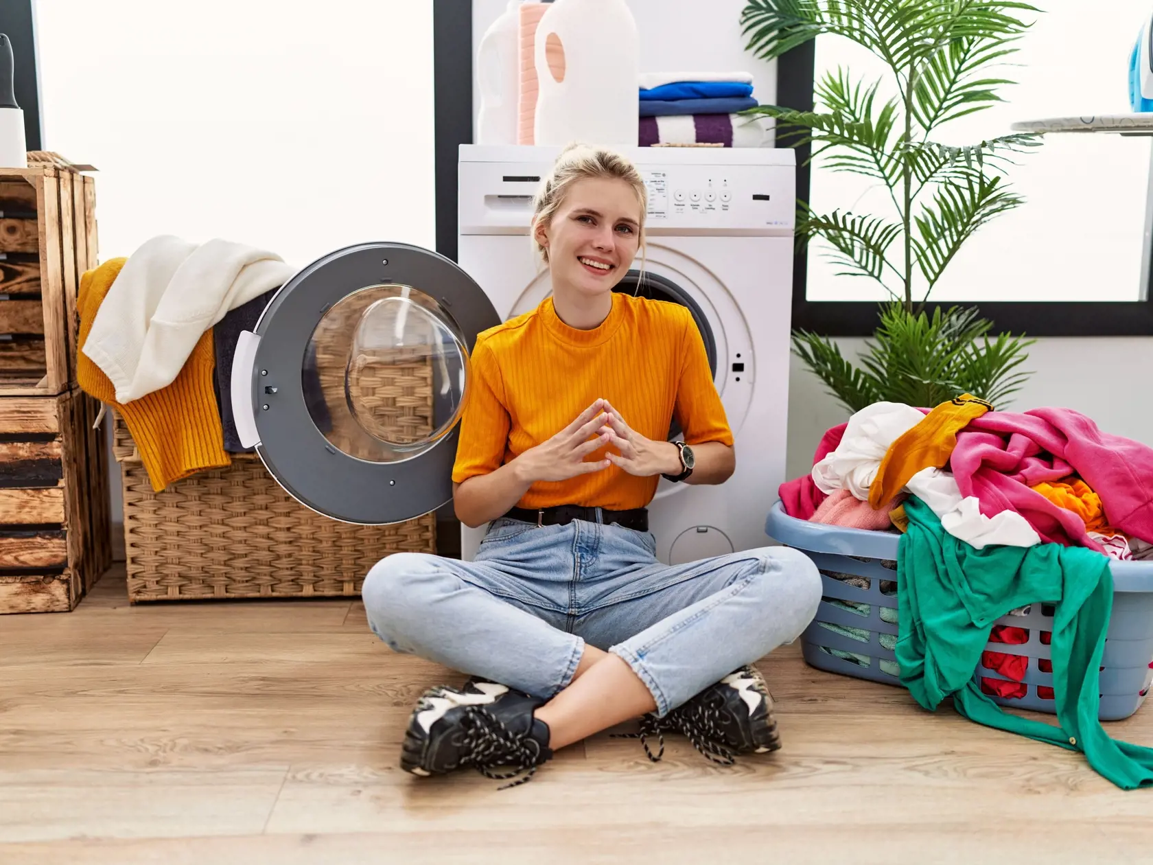 Young,Blonde,Woman,Doing,Laundry,Sitting,By,Washing,Machine,Hands