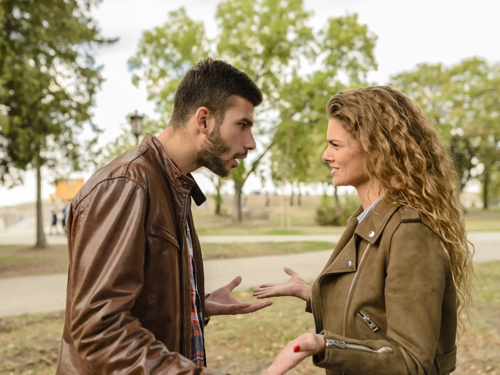 Young couple having a debate in the public park