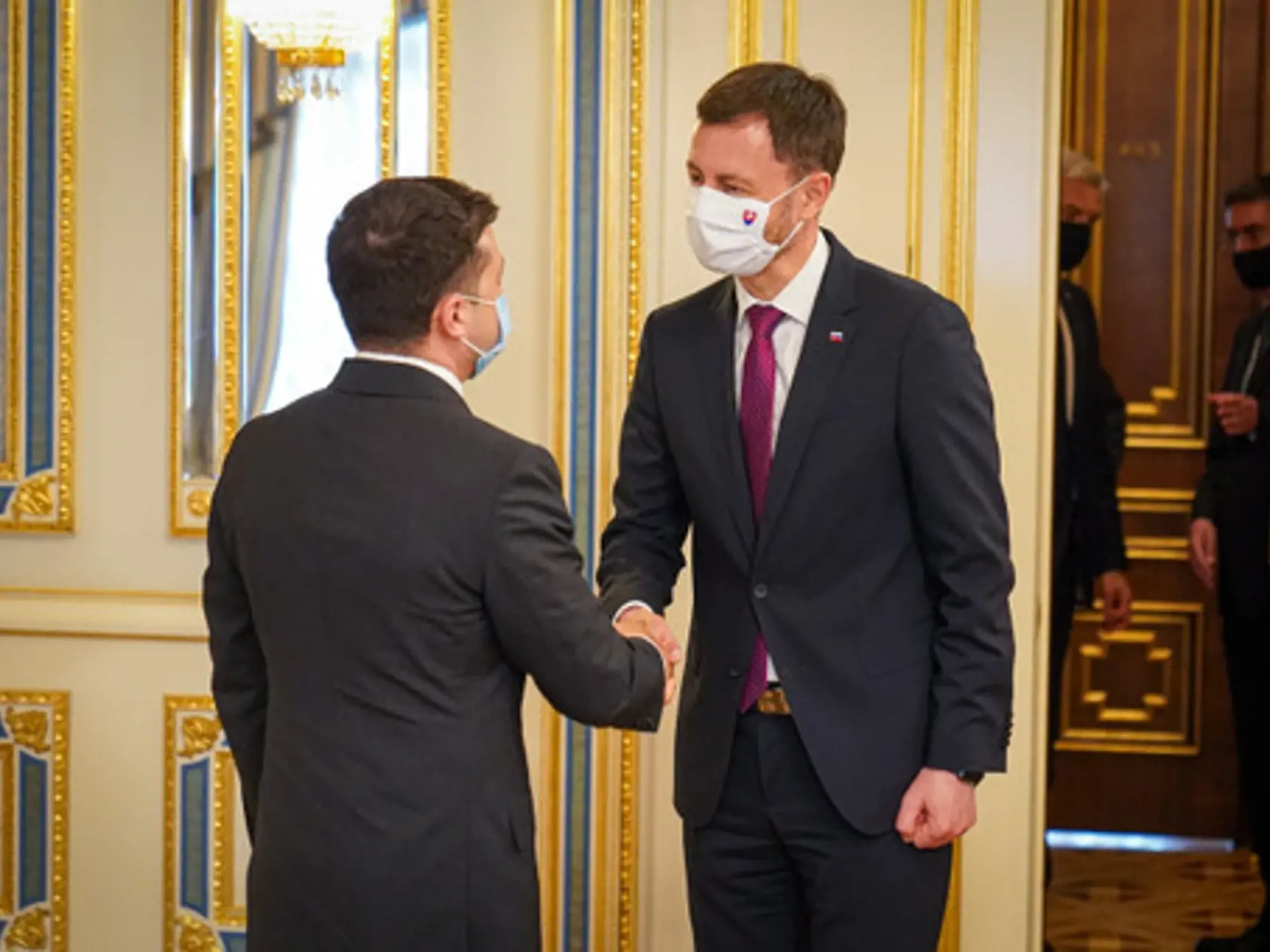 Slovenský premiér Eduard Heger (vľavo) a ukrajinský prezident Volodymyr Zelenskyj (uprostred) počas stretnutia v Kyjeve v piatok 8. apríla 2022.