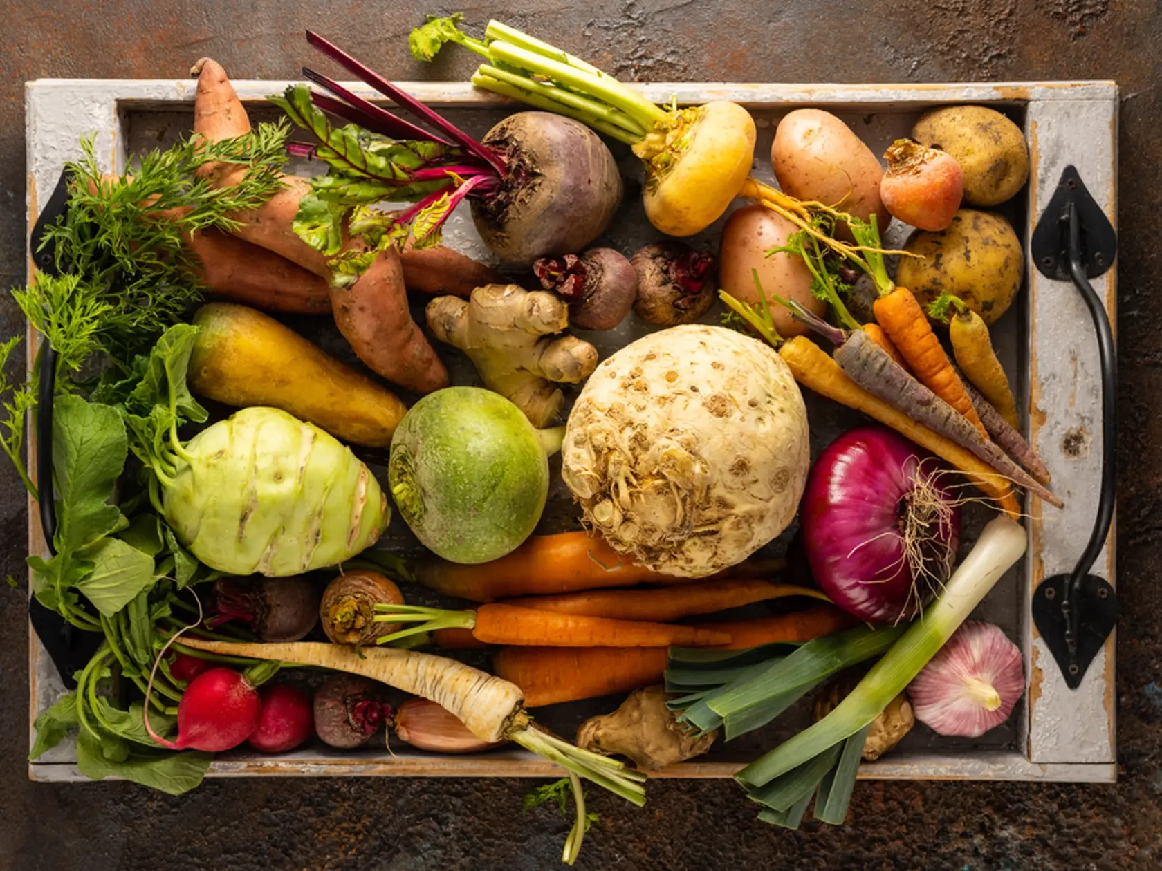Assortment of Vegetables and root vegetables in wooden tray. Autumn harvest. Healthy food and vegetarian concept.
