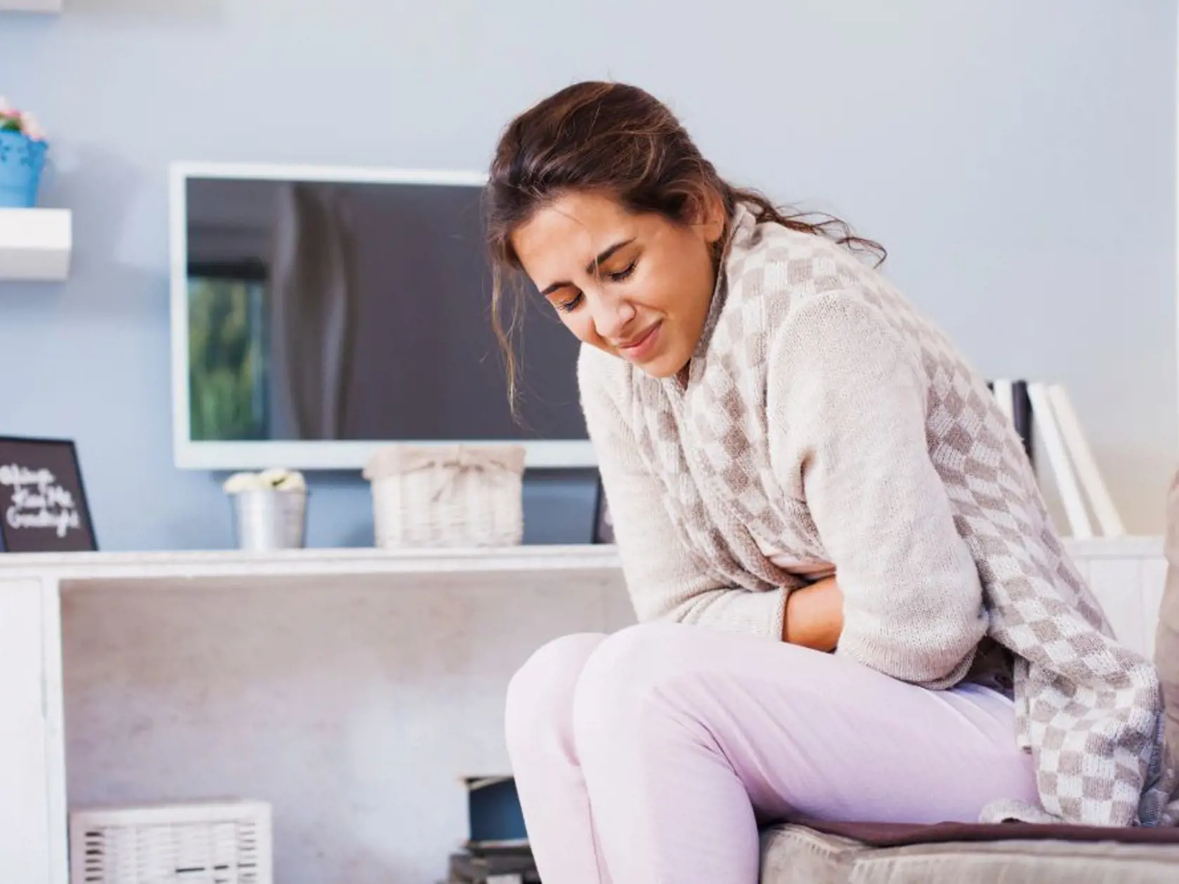 woman with hard stomach pain