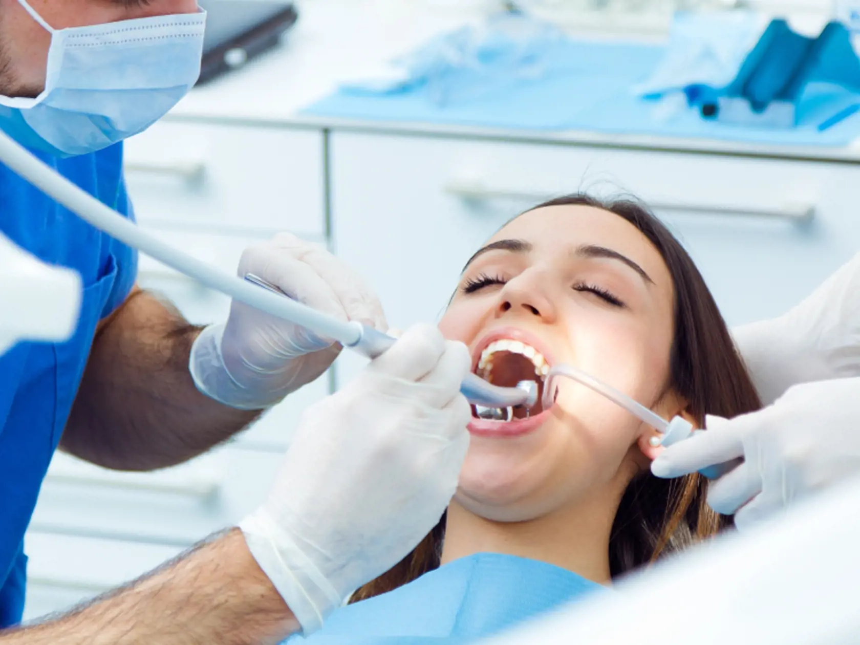 Medical scene of cute young woman at the dentist.