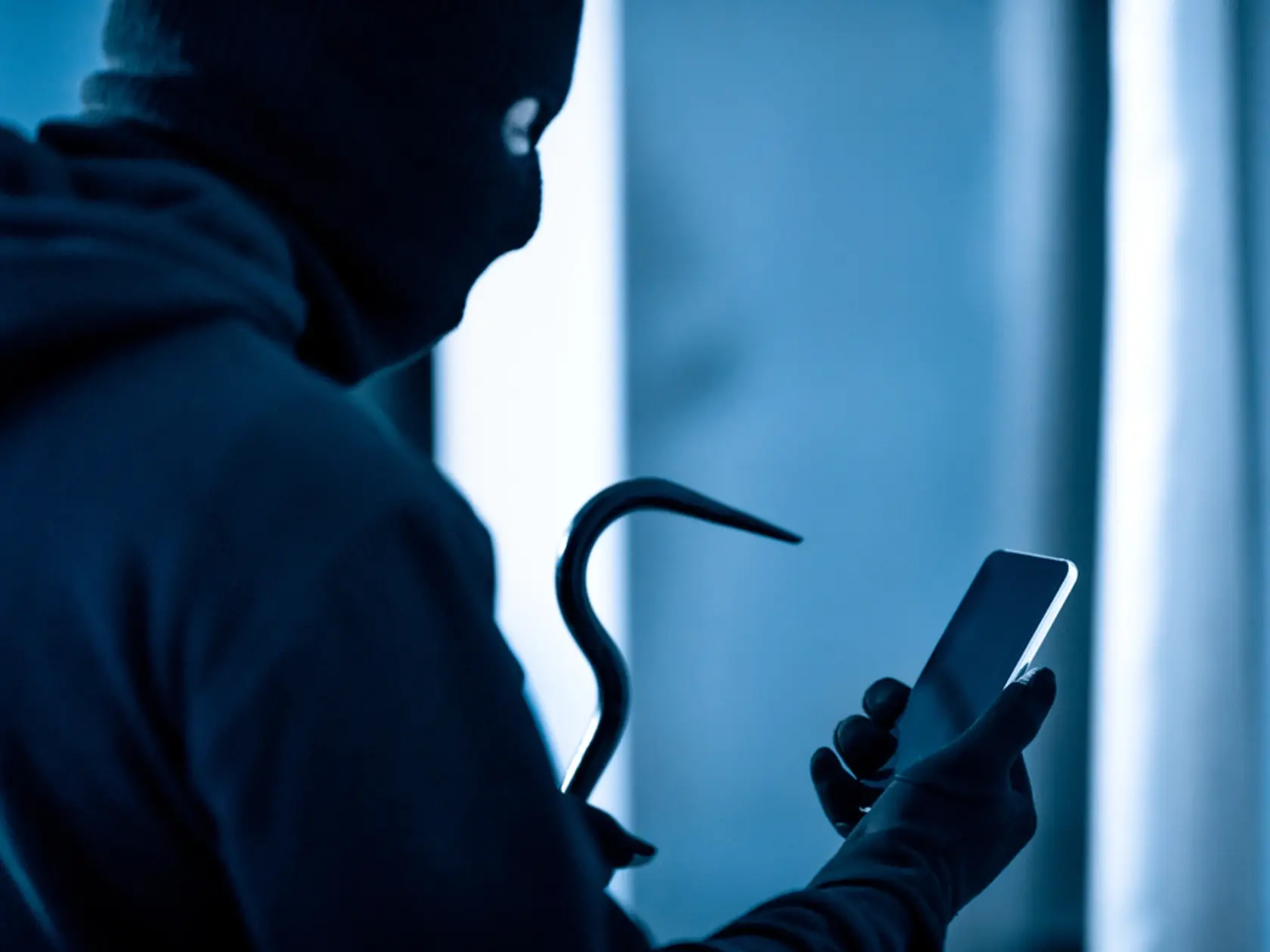 Robbery,Concept.,Masked,Villain,With,Crowbar,And,Smartphone,Preparing,Burglary