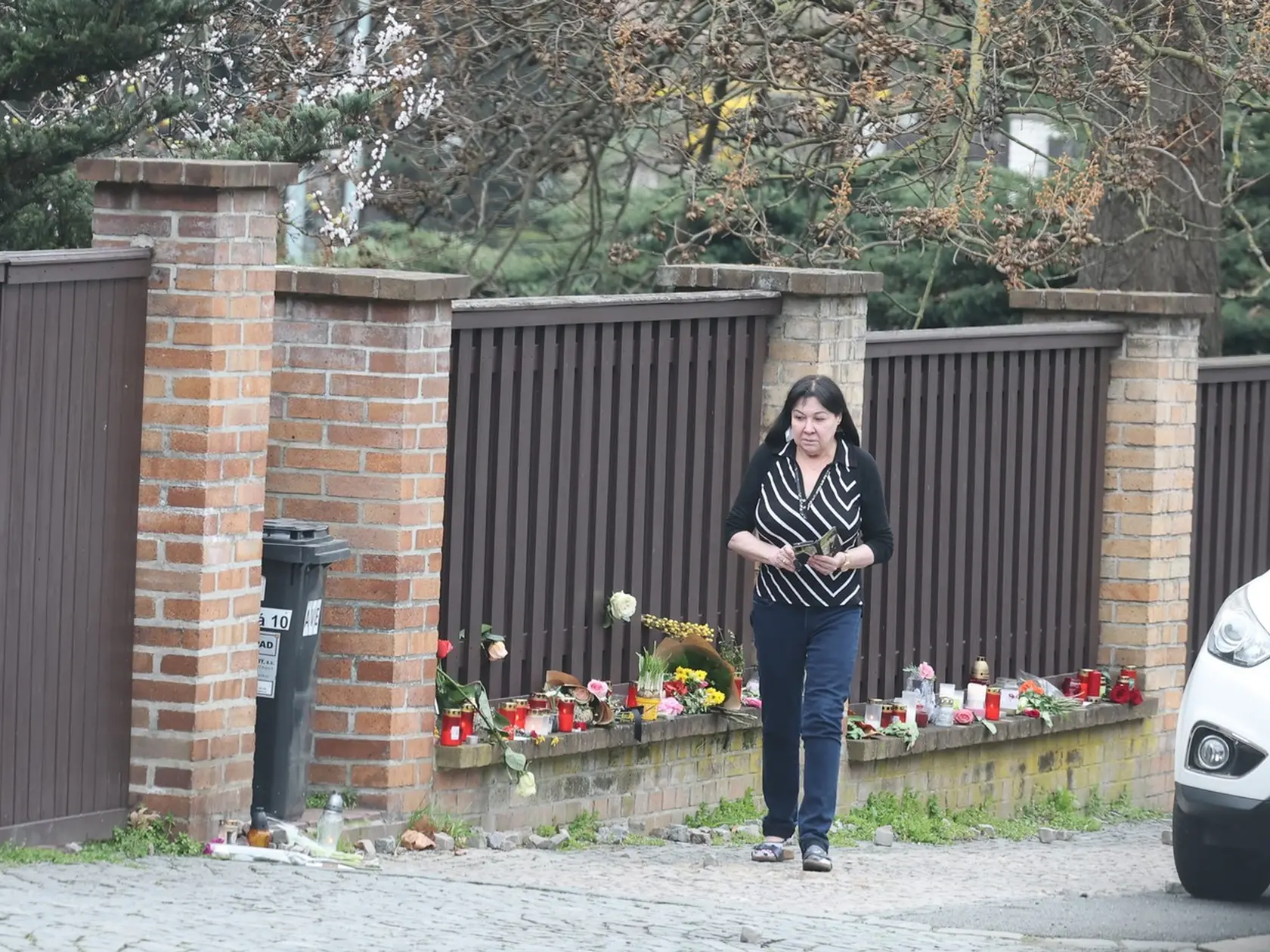 Dagmar Patrasová pri svojom dome, ku ktorému prinášajú ľudia kvety.