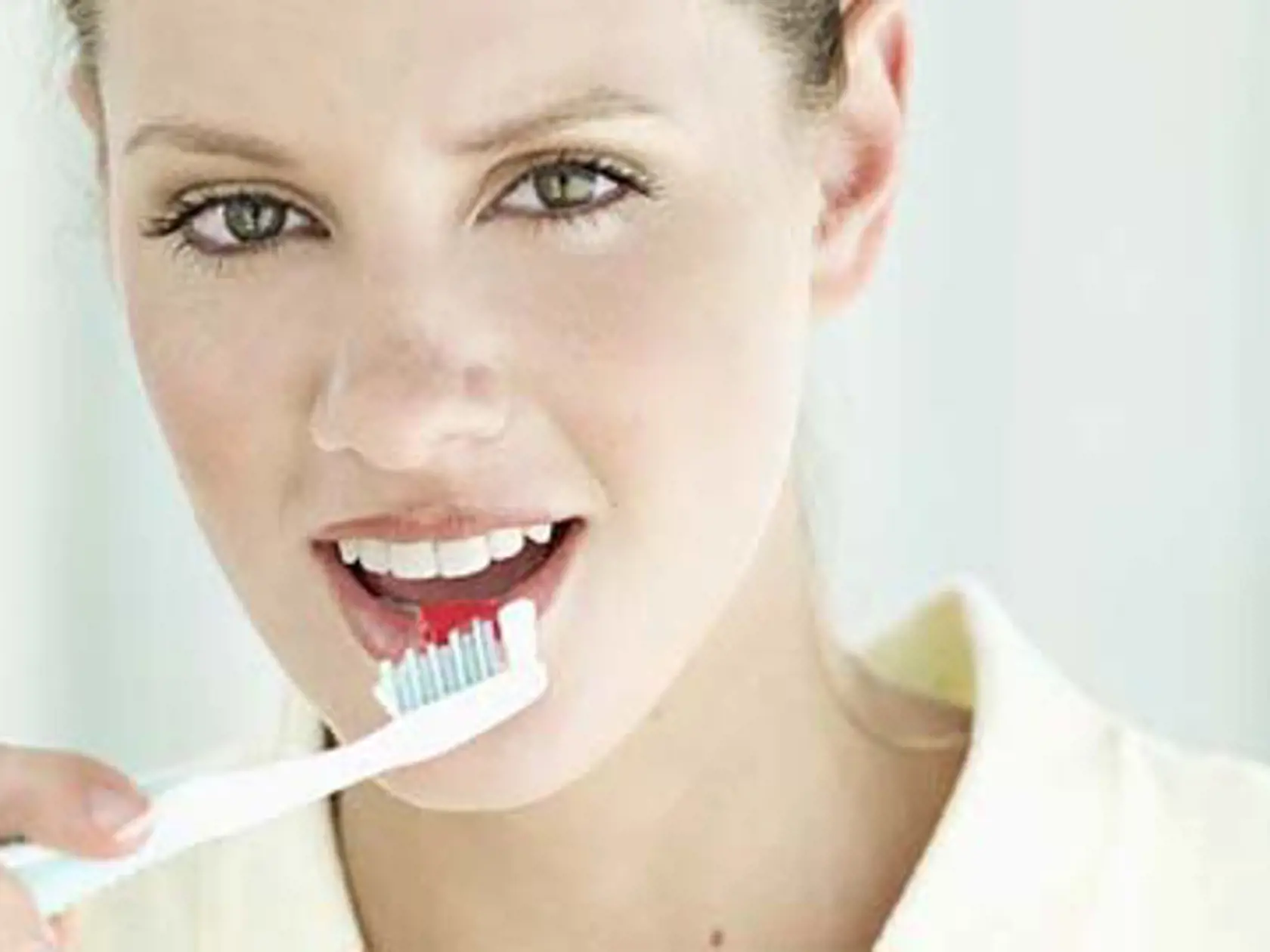 Young woman brushing her teeth