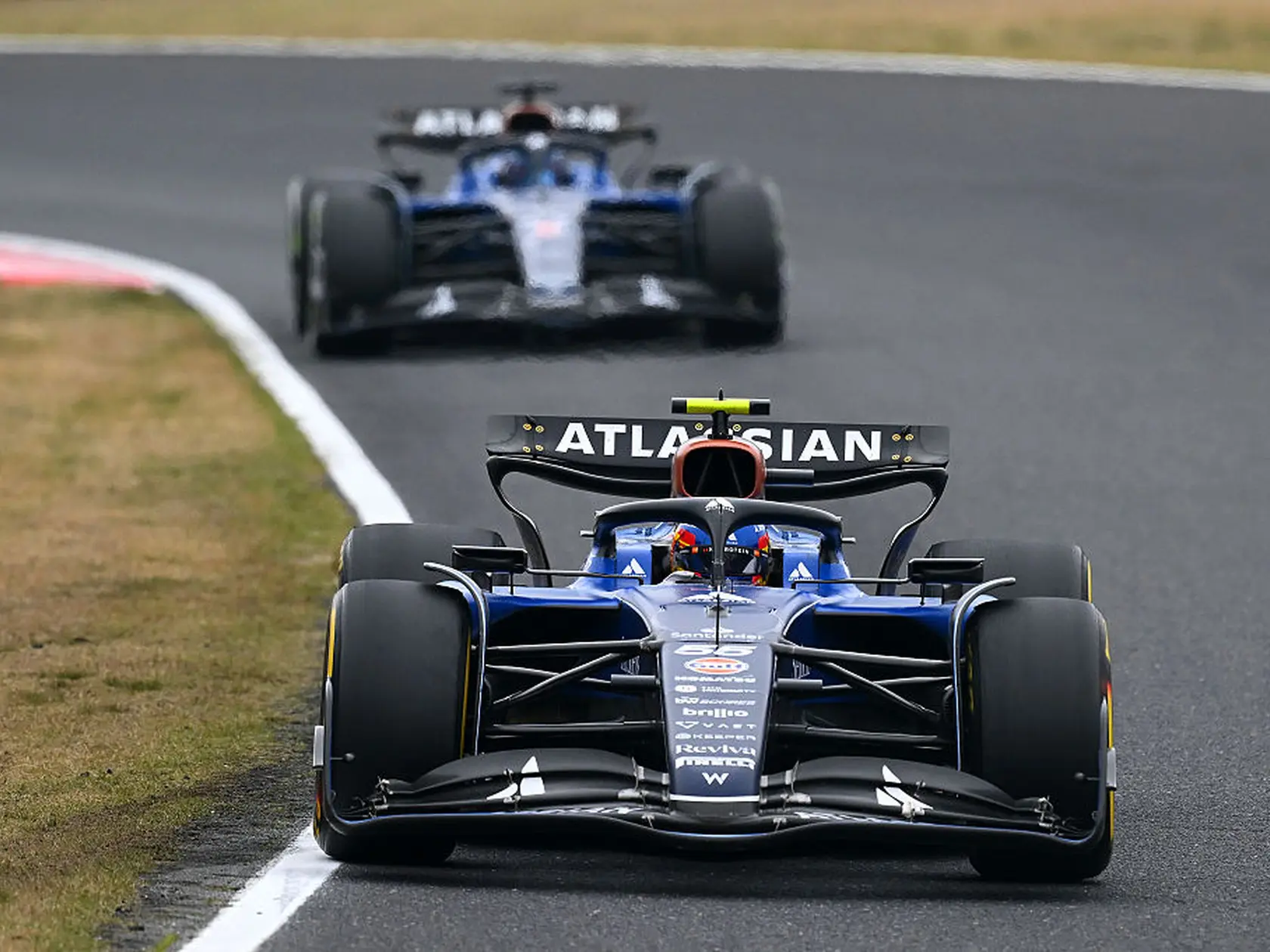 SUZUKA, JAPAN - APRIL 06: Carlos Sainz of Spain driving the (55) Williams FW47 Mercedes leads Alexander Albon of Thailand driving the (23) Williams FW47 Mercedes on track during the F1 Grand Prix of Japan at Suzuka Circuit on April 06, 2025 in Suzuka, Japan. (Photo by Clive Mason/Getty Images)