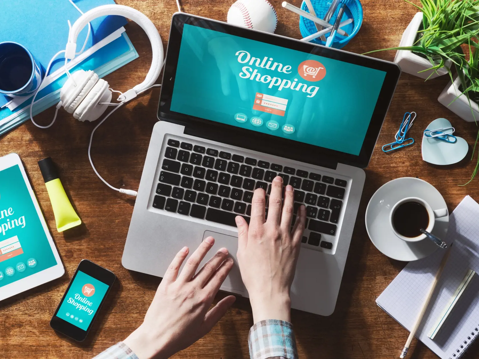 Online shopping website on laptop screen with female hands typing