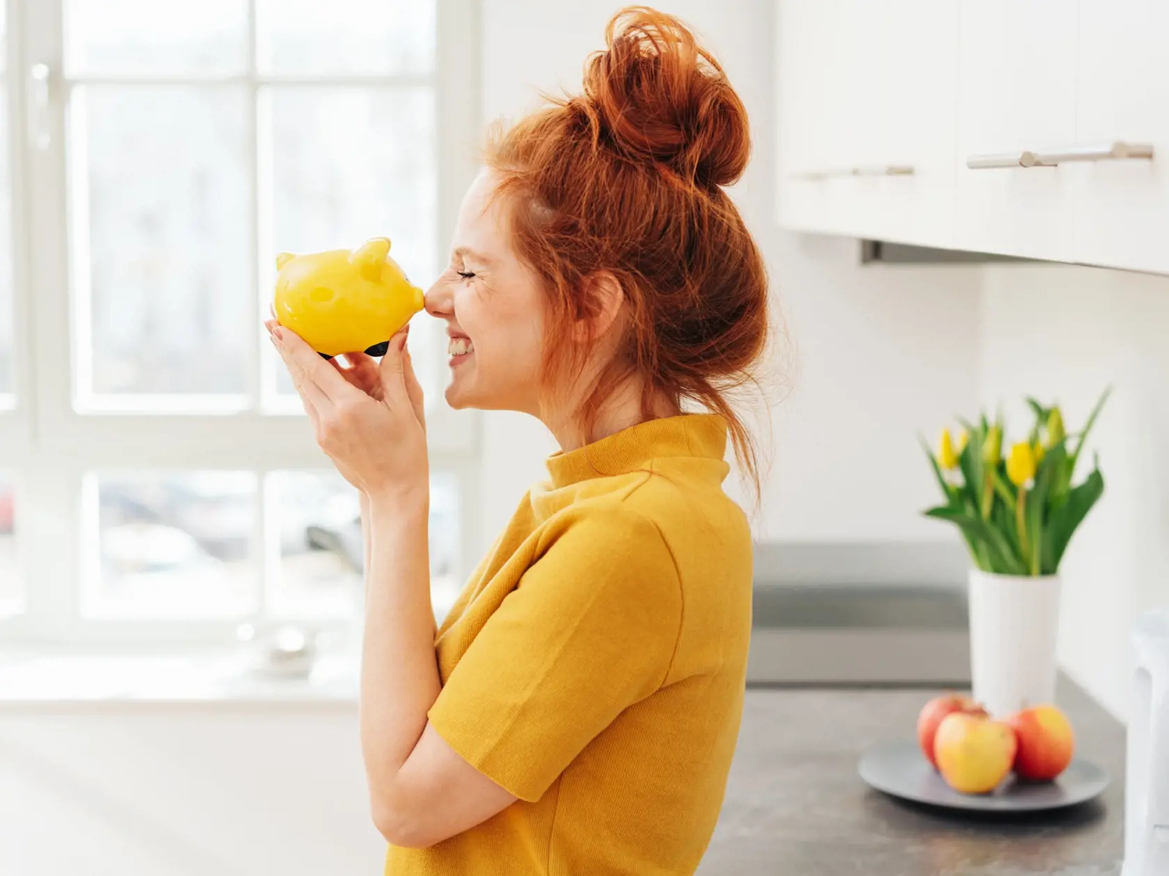 Smiling,Red-haired,Woman,Playing,With,Yellow,Piggy,Bank,In,Her