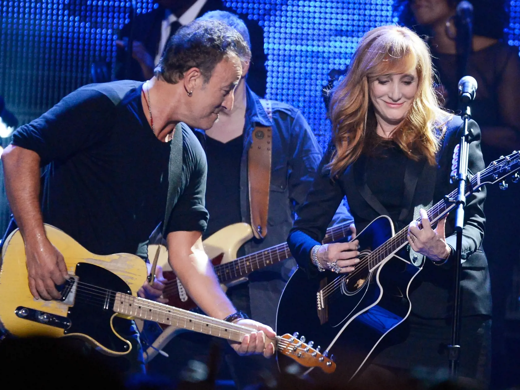 LOS ANGELES, CA - FEBRUARY 08:  Honoree Bruce Springsteen (L) and singer Patti Scialfa perform onstage at The 2013 MusiCares Person Of The Year Gala Honoring Bruce Springsteen at Los Angeles Convention Center on February 8, 2013 in Los Angeles, California.  (Photo by Kevork Djansezian/Getty Images)
