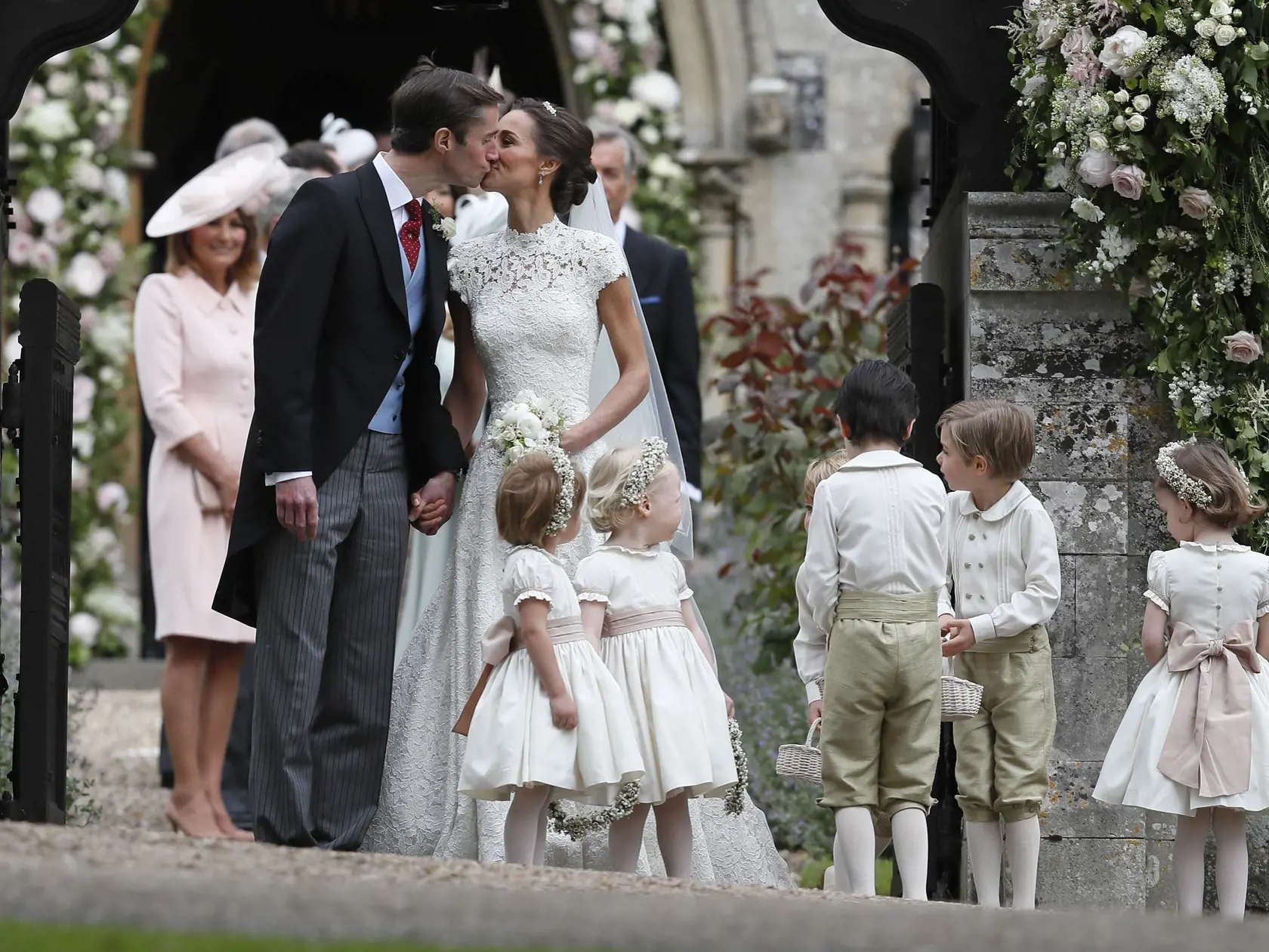 Pippa Middleton and James Matthews kiss after their wedding at St Mark's Church in Englefield, England Saturday, May 20, 2017. Middleton, the sister of Kate, Duchess of Cambridge married hedge fund manager James Matthews in a ceremony Saturday where her niece and nephew Prince George and Princess Charlotte was in the wedding party, along with sister Kate and princes Harry and William. (AP Photo/Kirsty Wigglesworth, Pool)