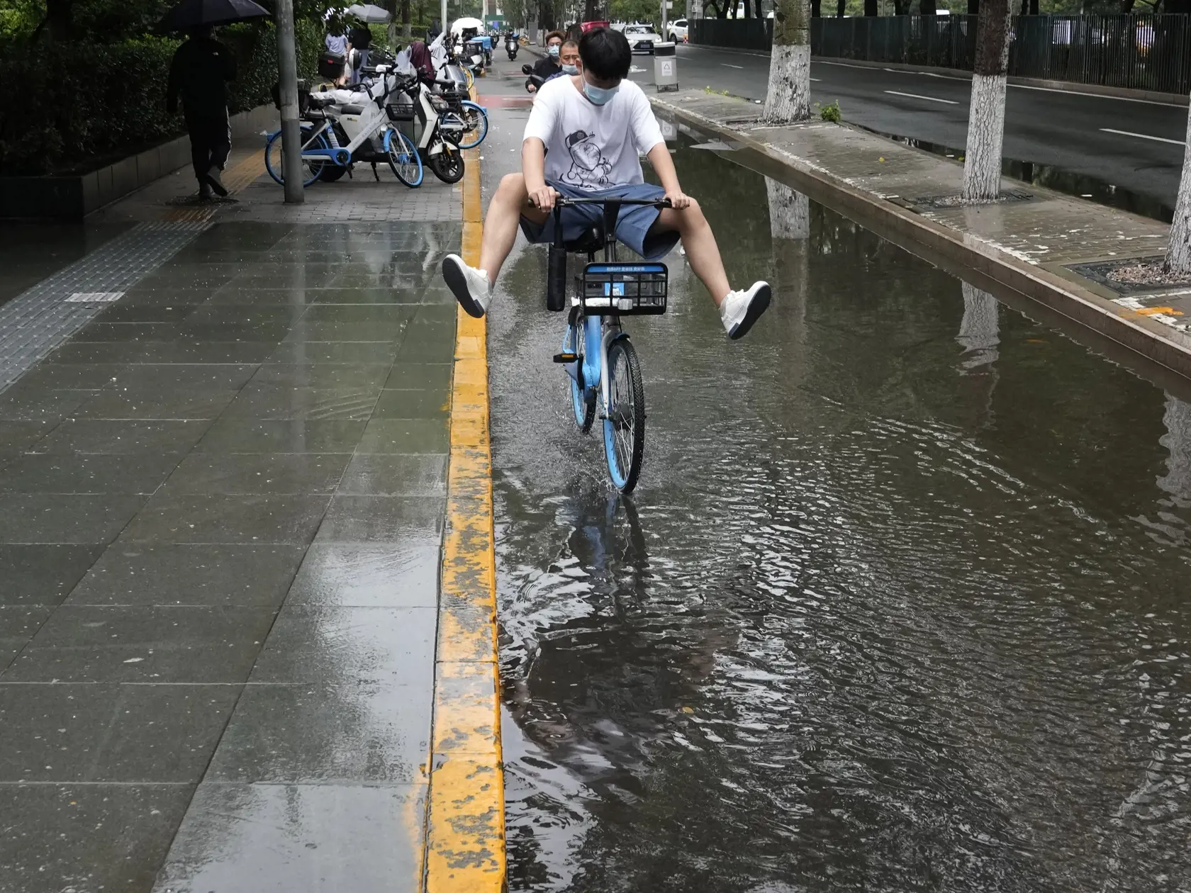 EBE 18 Peking - Na snímke muž s ochranným rúškom dvíha nohy idúc na bicykli cez kalužu v čínskom Pekingu 12. júla 2022. FOTO TASR/AP


A man wearing a mask lifts up his feet as he cycles through a puddle, Tuesday, July 12, 2022, in Beijing. (AP Photo/Ng Han Guan)