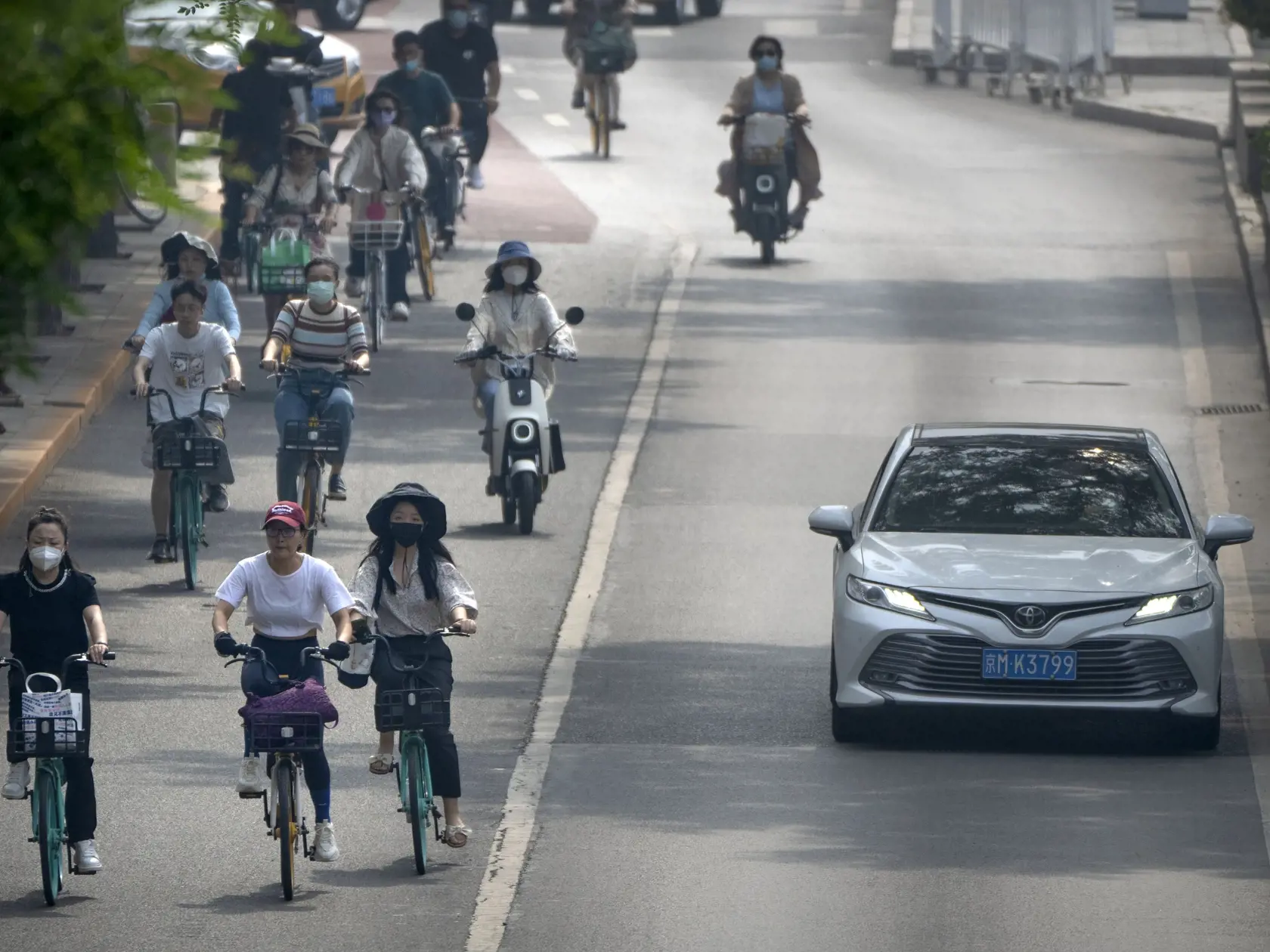 JB 23 Peking - Ľudia s ochrannými rúškami jazdia na bicykli na ulici v čínskom Pekingu 17. júna 2022. Peking postupne ruší protipandemické opatrenia; otvorili sa školy aj reštaurácie. FOTO TASR/AP

Commuters wearing face masks ride bicycles along a street in the central business district in Beijing, Friday, June 17, 2022. (AP Photo/Mark Schiefelbein)