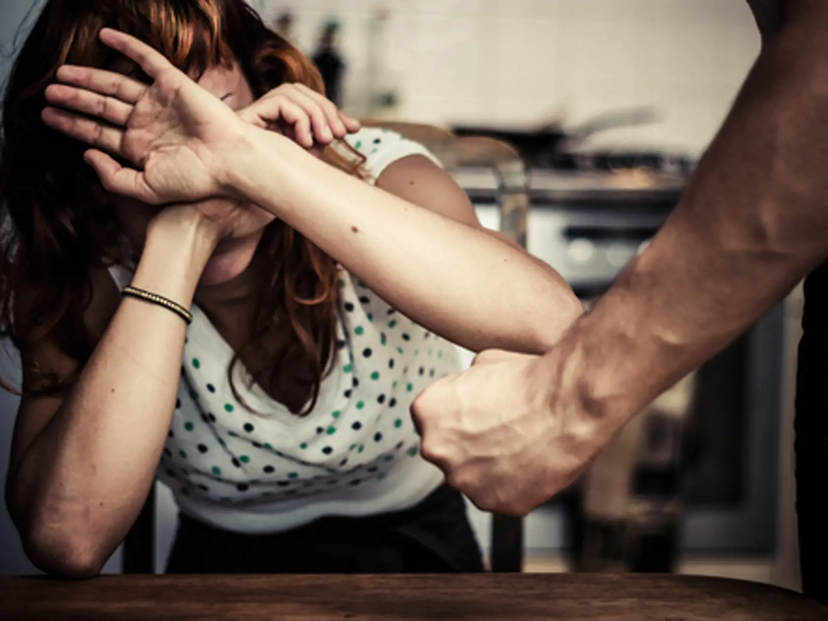 Woman covering her face in fear of domestic violence
