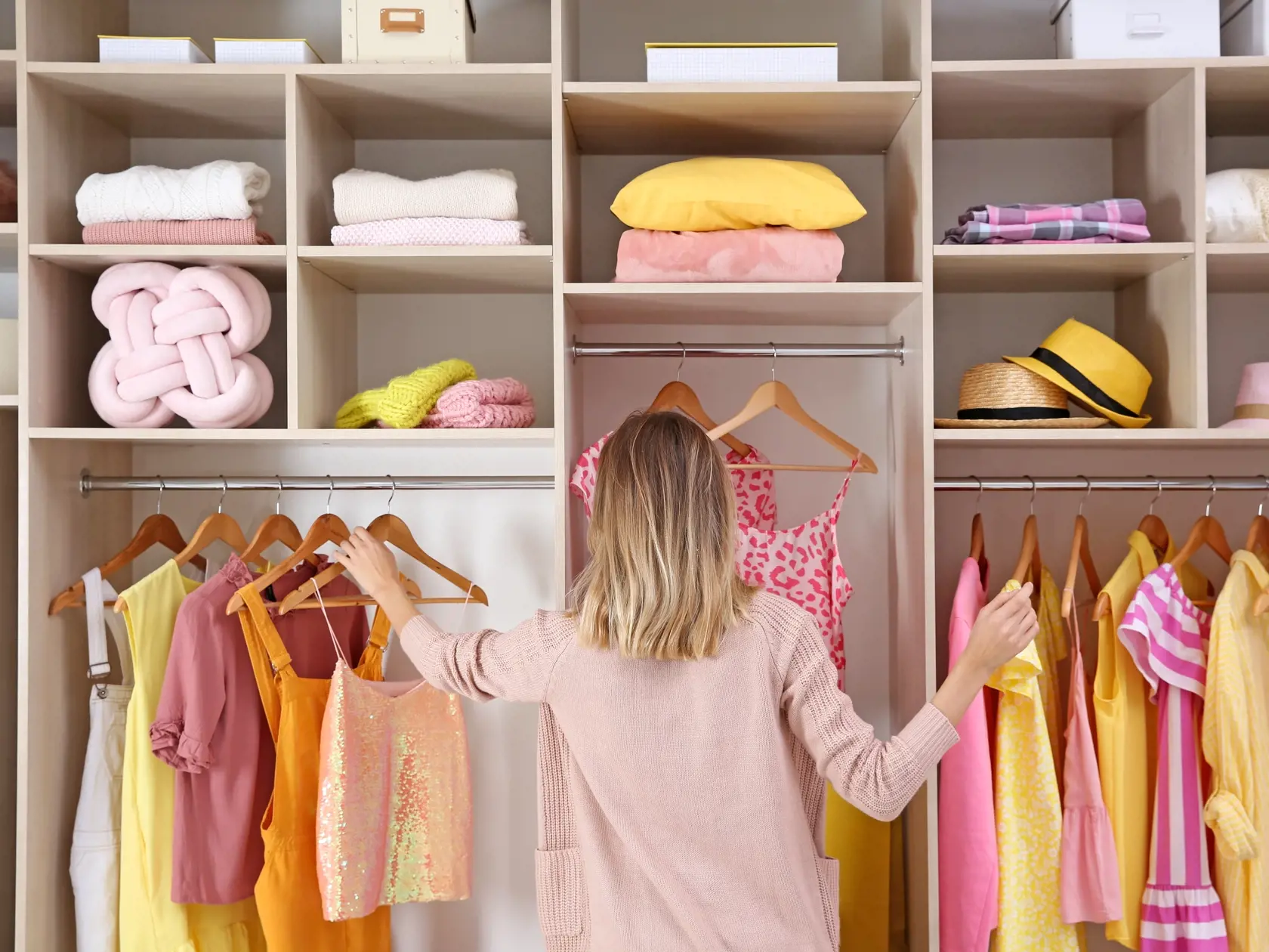 Woman,Choosing,Clothes,From,Large,Wardrobe,Closet