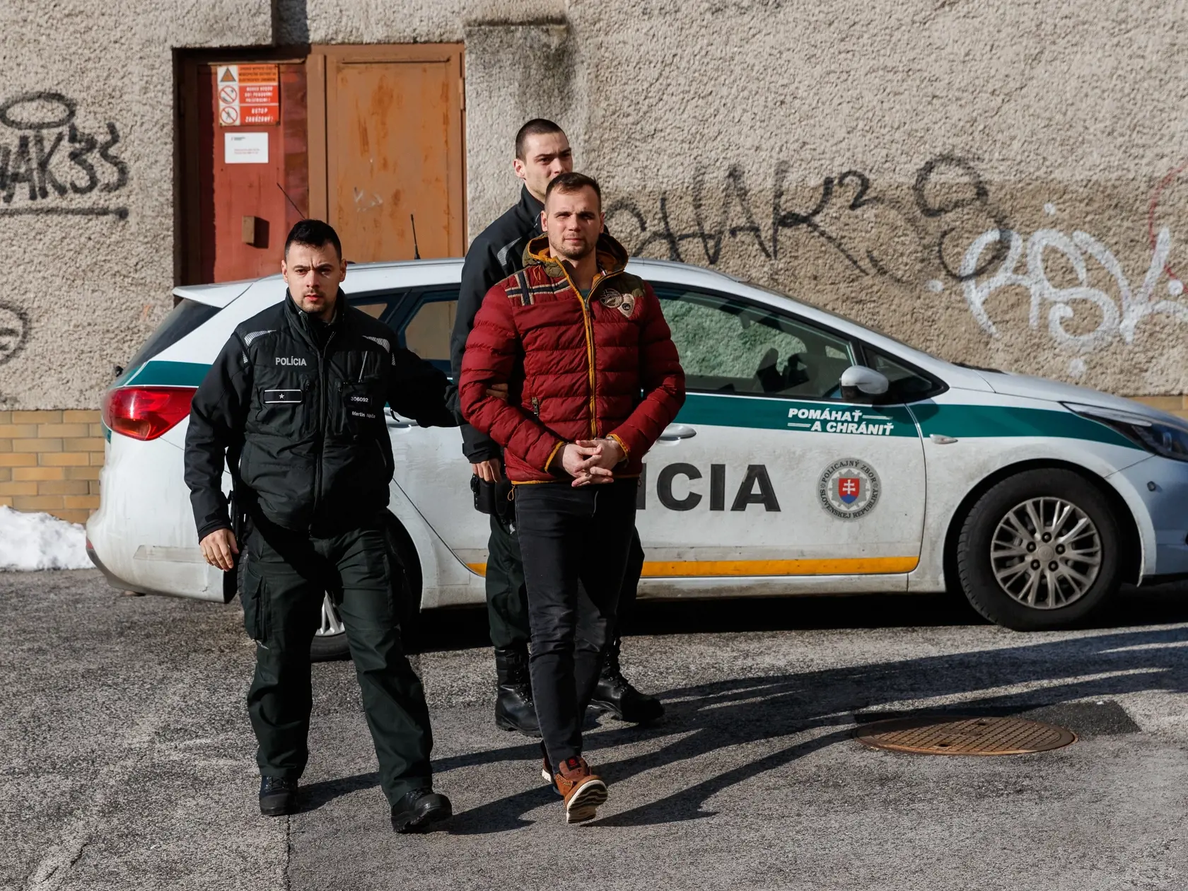 Príslušníci Policajného zboru Slovenskej republiky privádzajú pred sudcu Okresného súdú Bratislava IV starostu obce Malé Leváre,  Adriana Perneckého, proti ktorému  bolo vedené trestné stíhanie vo veci prečinu nebezpečného vyhrážania. (archívne foto)