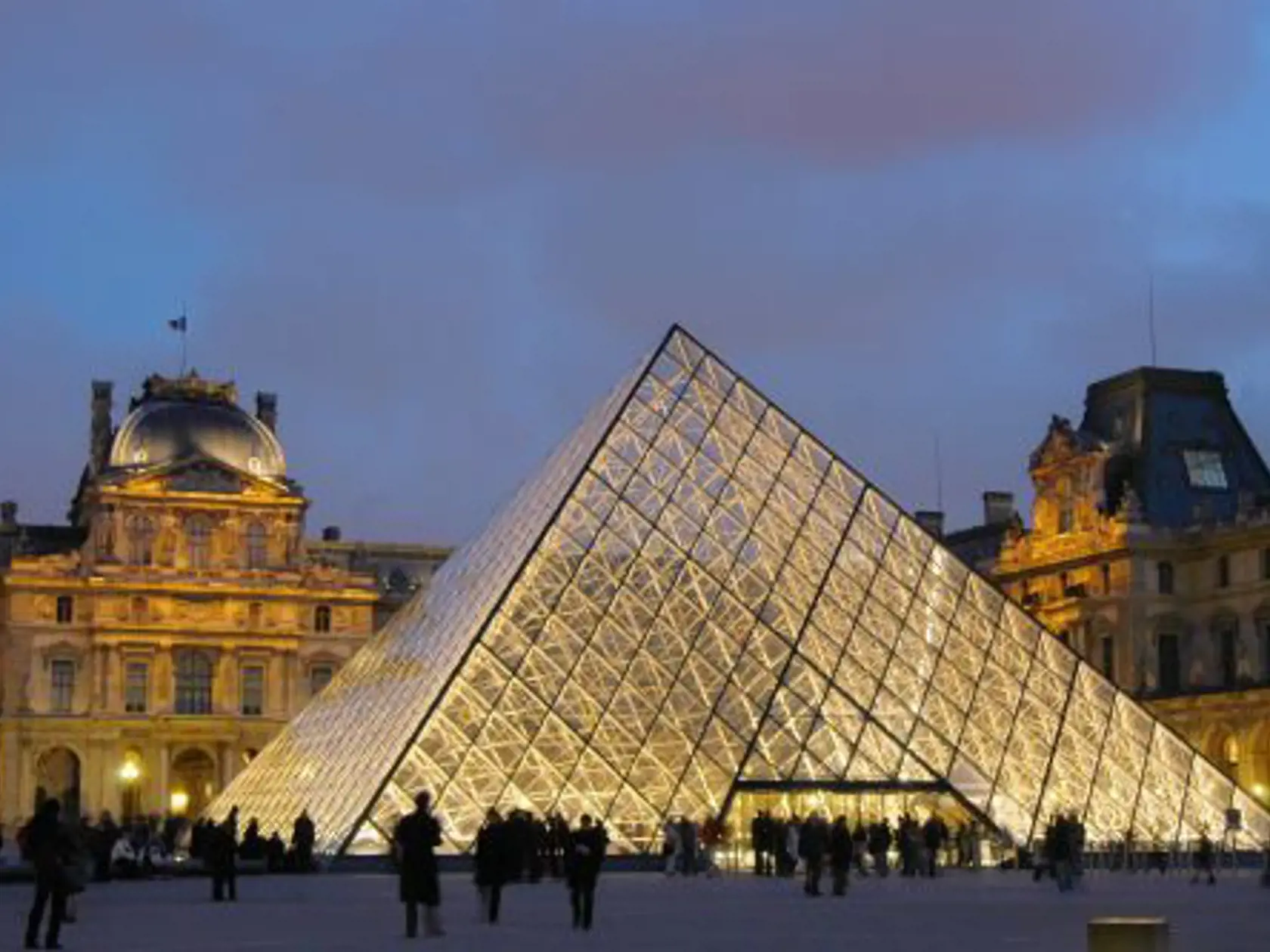 ** FILE ** View of the pyramid and the Louvre Museum building in this Jan. 22, 2005 file photo in Paris. The Louvre Museum in Paris had a record number of visitors in 2005, with successful soirees for young people, crowd-pleasing exhibitions and promotion from "The Da Vinci Code," a top administrator said Tuesday, Jan. 3, 2006. (AP Photo/Claude Paris, file)