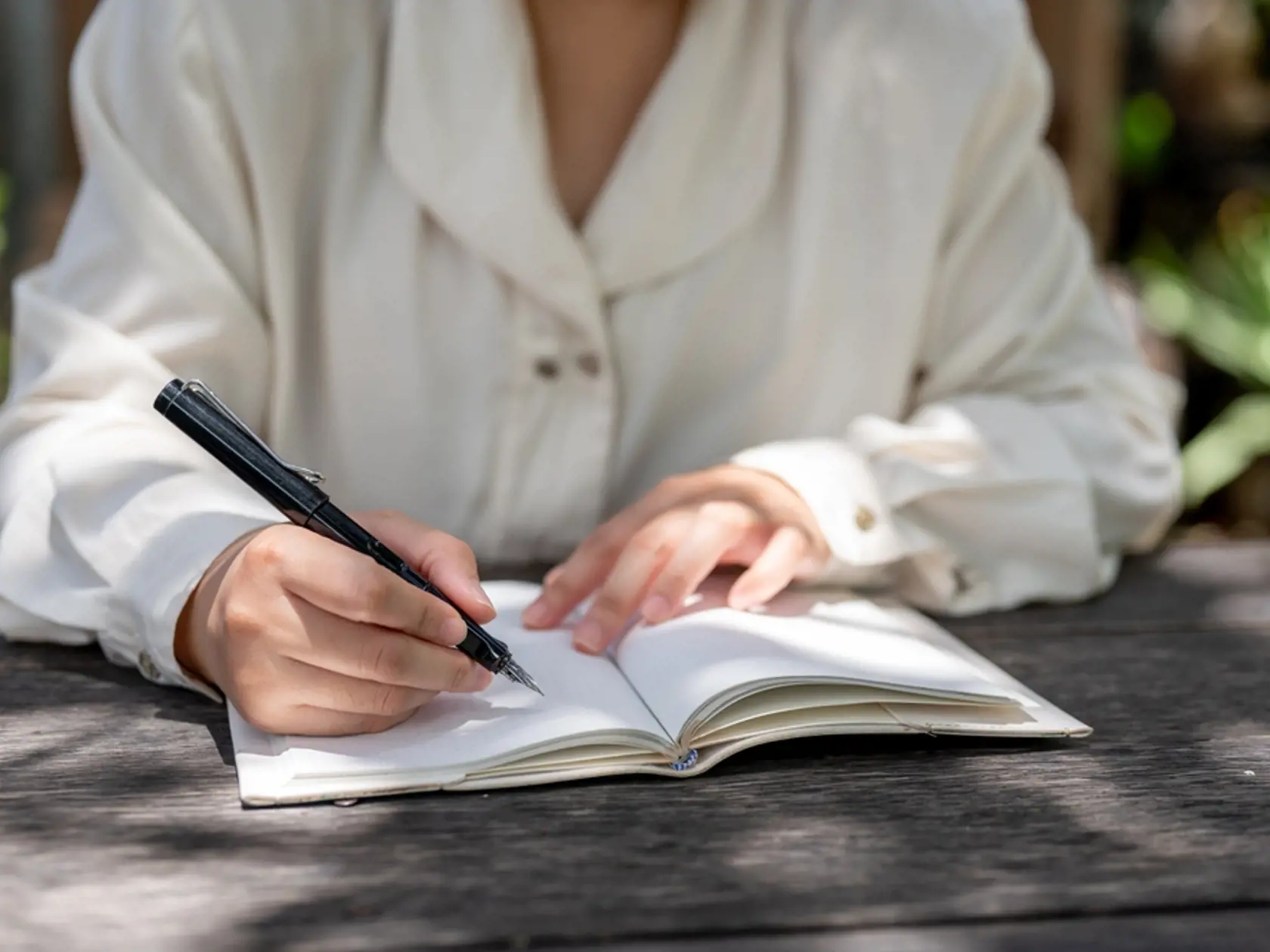 A,Cropped,Image,Of,A,Woman,Writing,Something,In,A