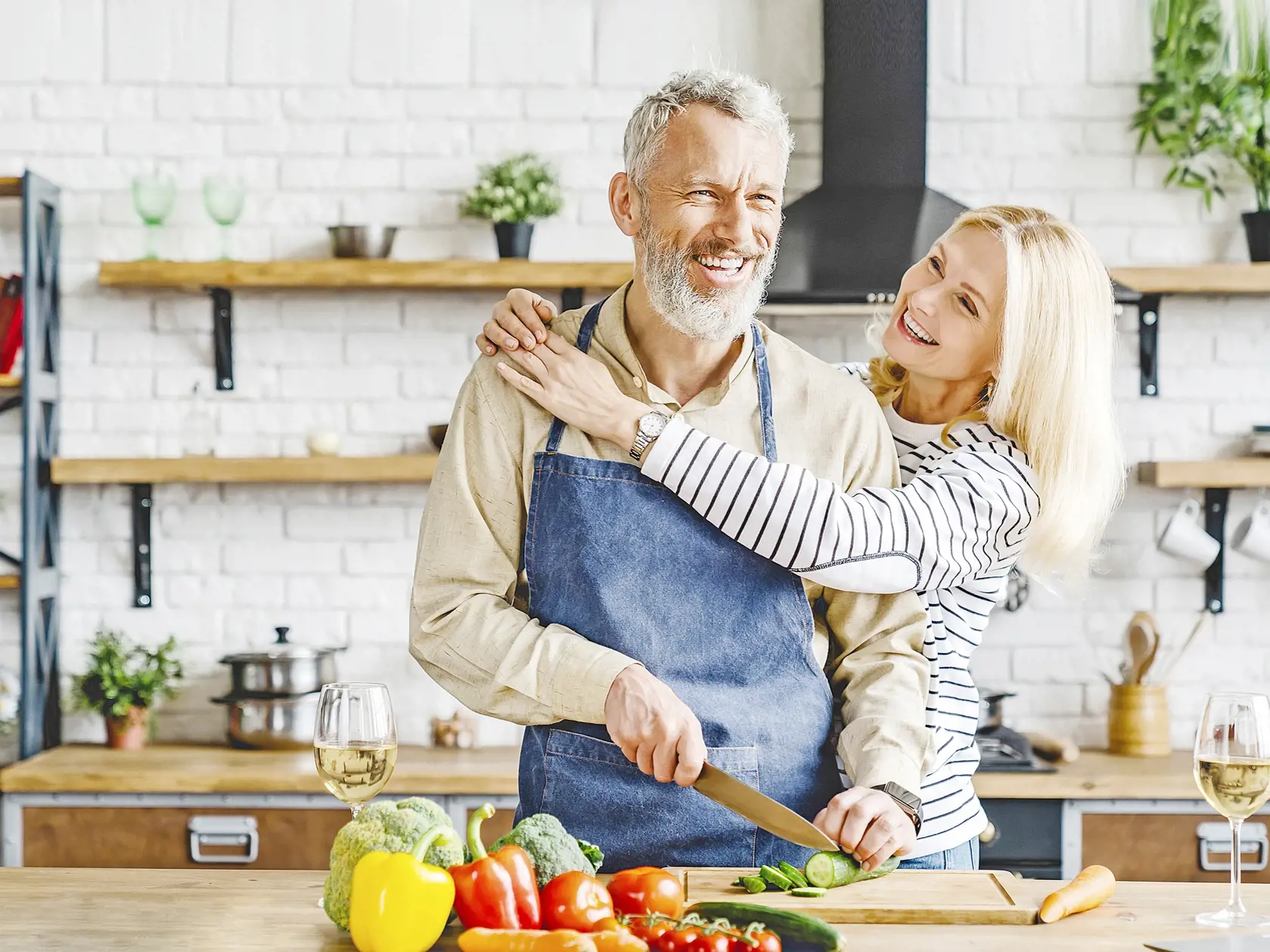 Senior,Couple,Spending,Time,Together,While,Cutting,Vegetables,At,Kitchen