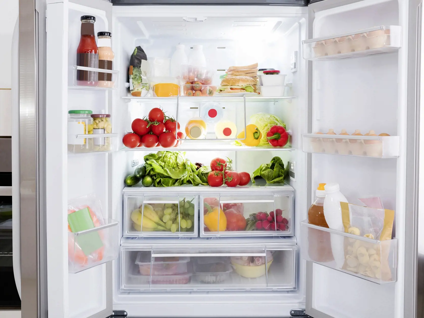 Open Refrigerator Filled With Fresh Fruits And Vegetable