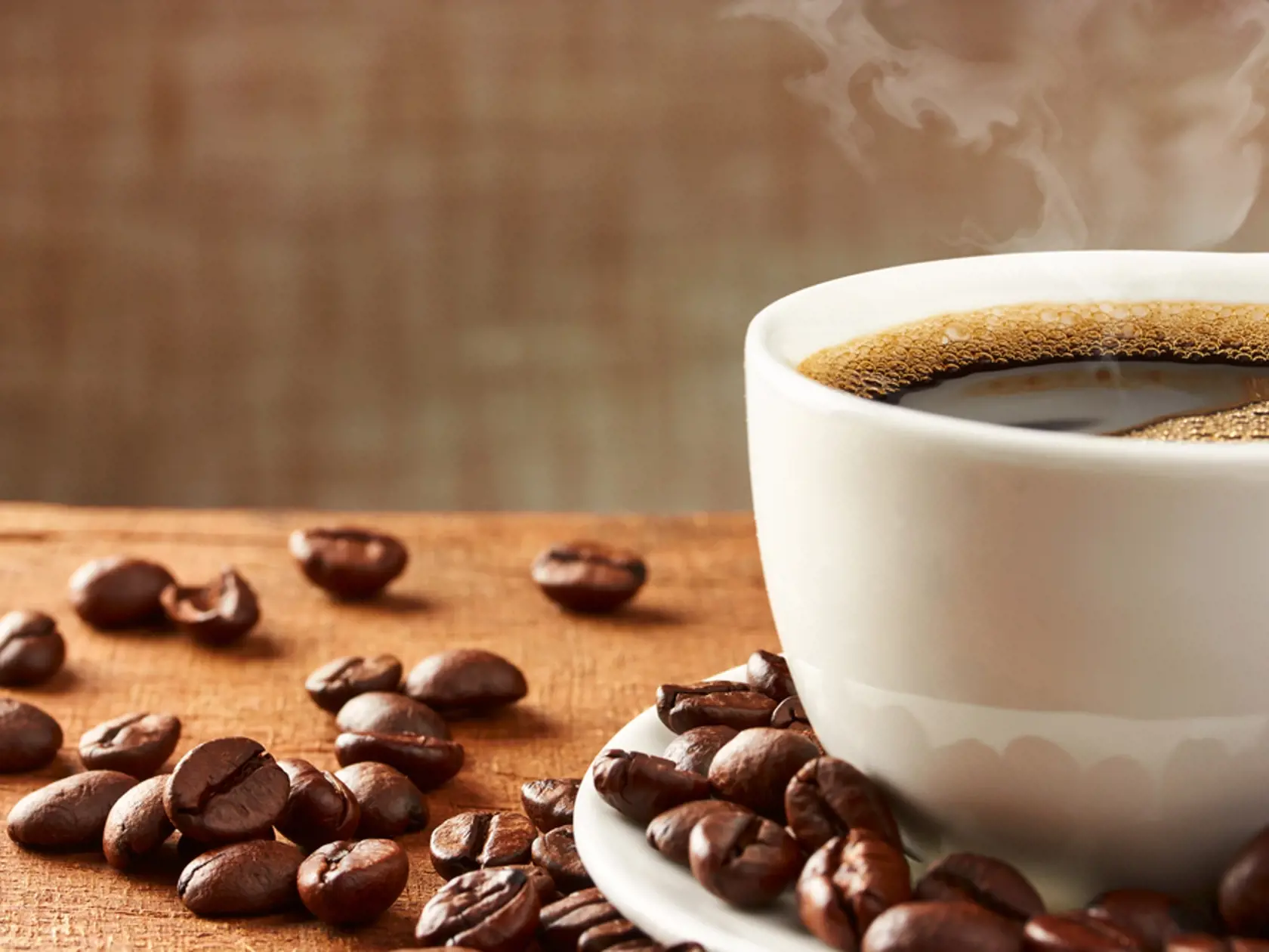 Coffee,Cup,And,Coffee,Beans,On,Table