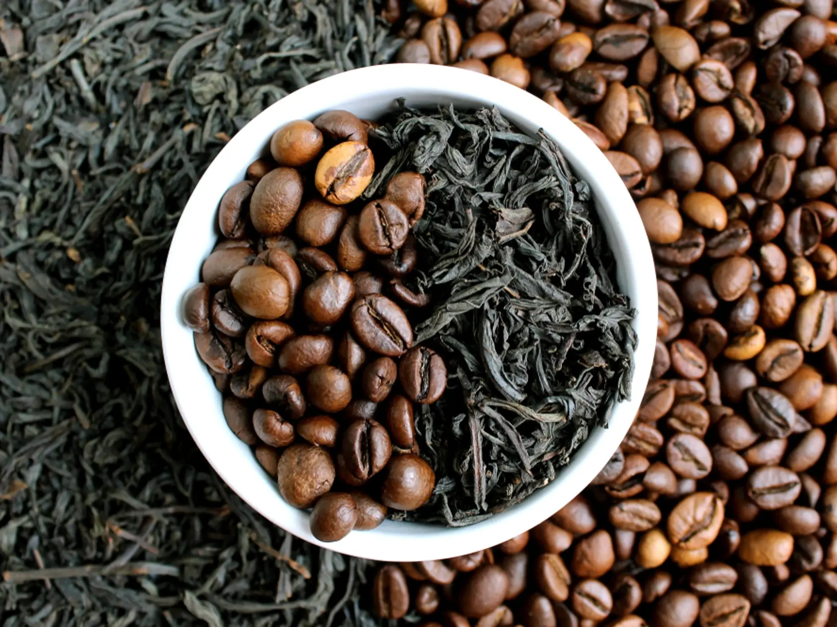 Coffee,Beans,And,Tea,In,Leaves,On,The,Same,Plate