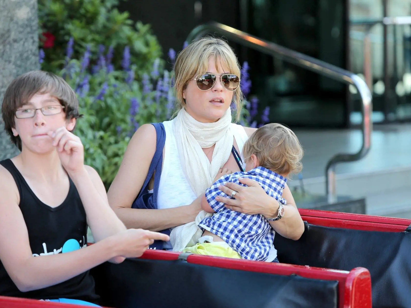 Studio City, CA - Selma Blair and her little man Arthur spend some mommy and son time at the Farmer's Market in Studio City.  The actress and her son enjoyed the petting zoo and jumped aboard the end of a train ride with some friends.  While on the train, Arthur kept reach out for his mom, and then the actress started breastfeeding him while on the short ride.  Selma kept a summery look in a white tank, lightweight scarf, Siwy cut off shorts, and her new blonde do in a low bun.          August 1