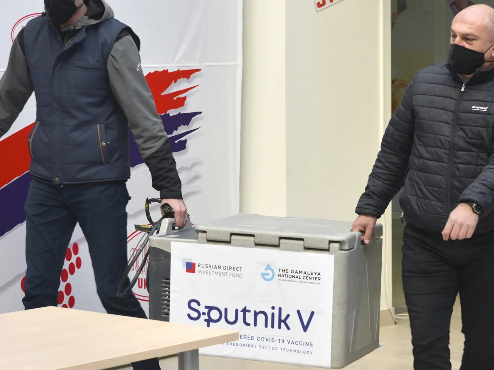 KK32 Banja Luka - Pracovníci nesú prepravnú nádobu s ruskou vakcínou Sputnik V počas očkovania zdravotníkov proti ochoreniu Covid-19, v bosnianskom meste Banja Luka 12. februára 2021. V Bosne a Hercegovine začali v piatok očkovať proti novému koronavírusu ruskou vakcínou Sputnik V. Očkovaciu látku tam však zatiaľ podávajú iba zdravotníkom, keďže momentálne jej majú len malé množstvo. FOTO TASR/AP
Workers hold a container of Russian Sputnik V, COVID-19 vaccines, during a ceremony of initiation of